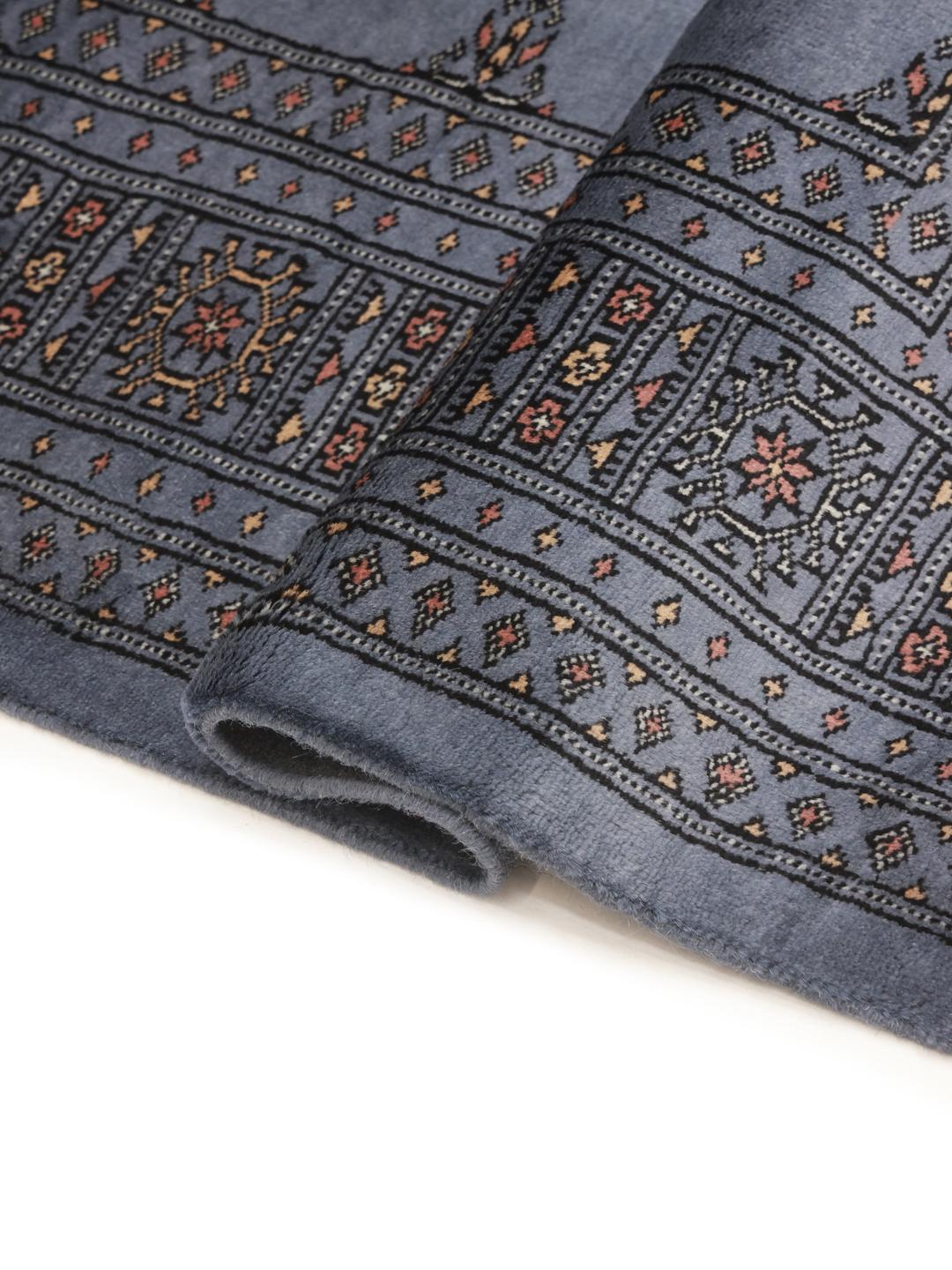 Handmade Pakistan wool rug in blue with traditional patterns