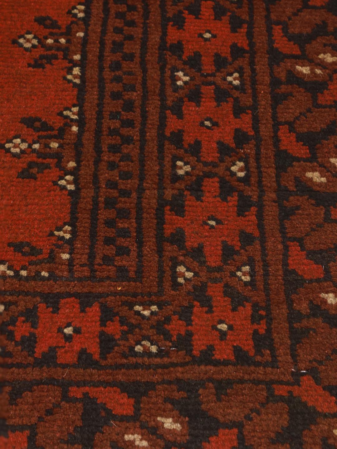 Handmade red Afghan rug with traditional motifs