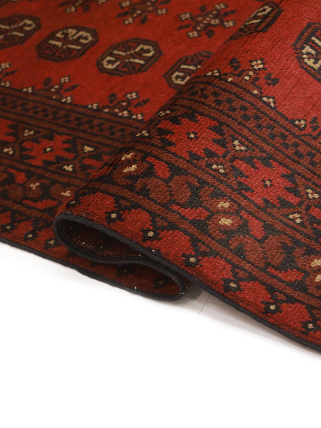 Handmade red Afghan rug with traditional motifs