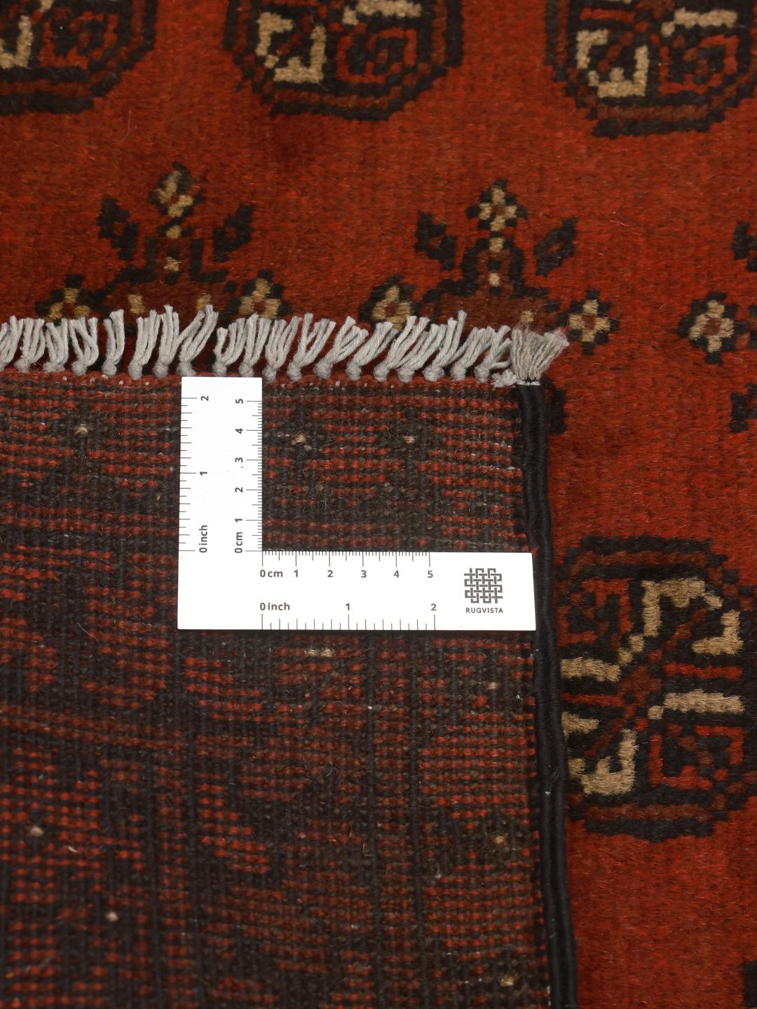 Handmade red Afghan rug with traditional motifs