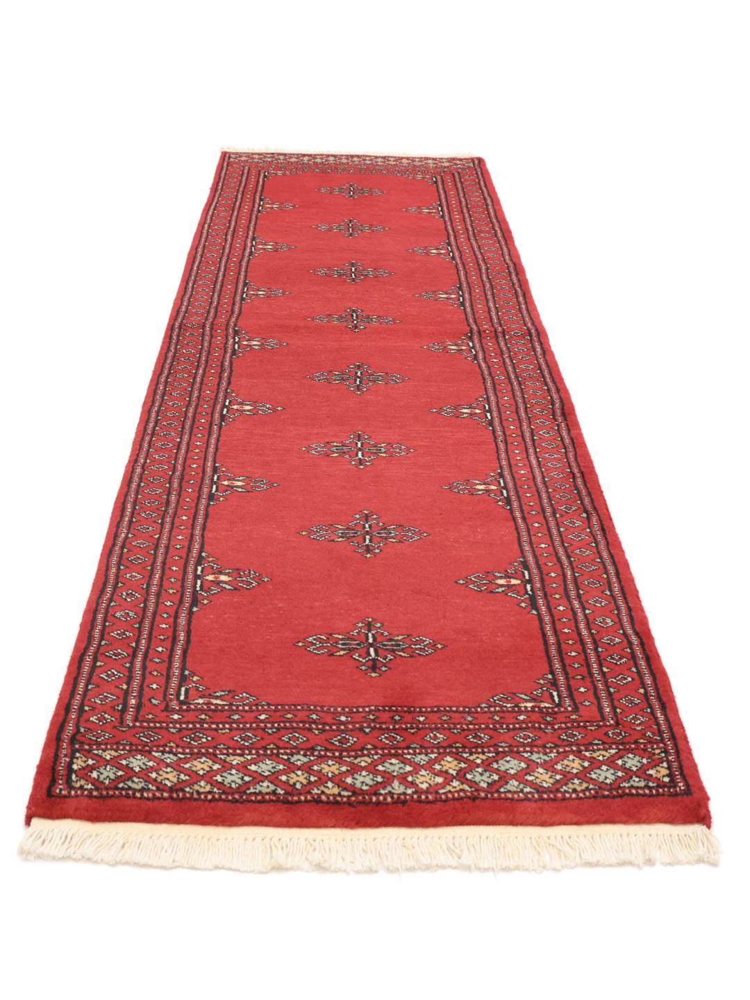 Red Pakistani wool runner rug with traditional motifs