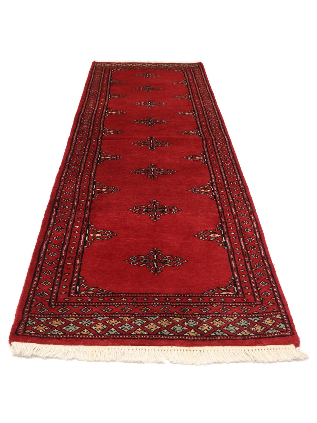 Red Pakistani wool runner rug with traditional motifs