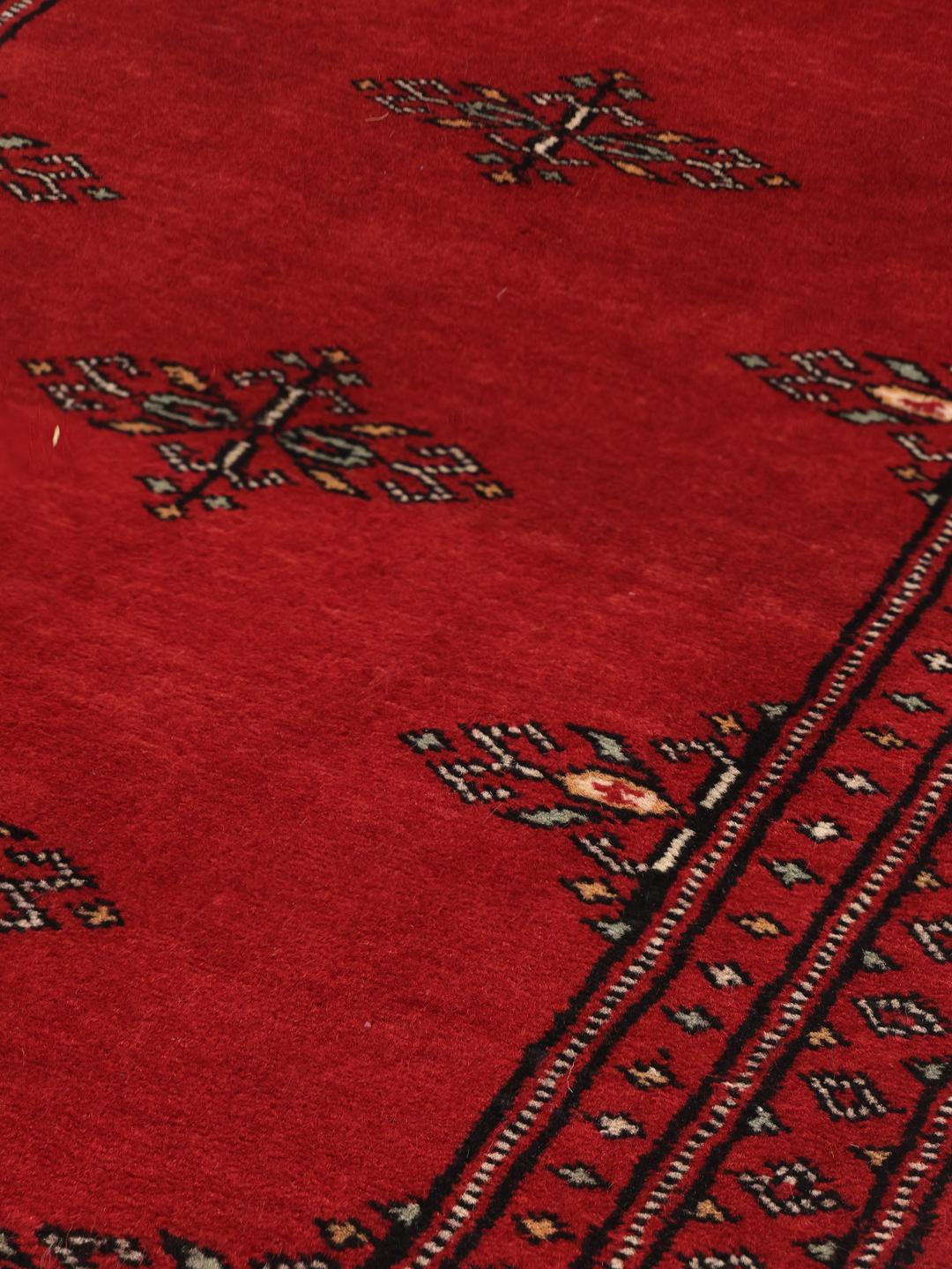 Red Pakistani wool runner rug with traditional motifs