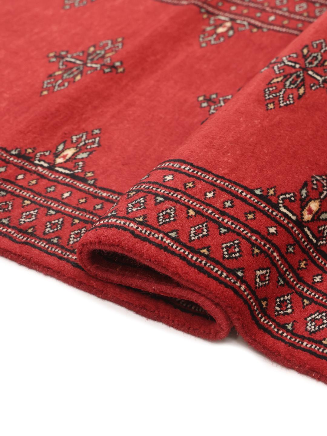Red Pakistani wool runner rug with traditional motifs