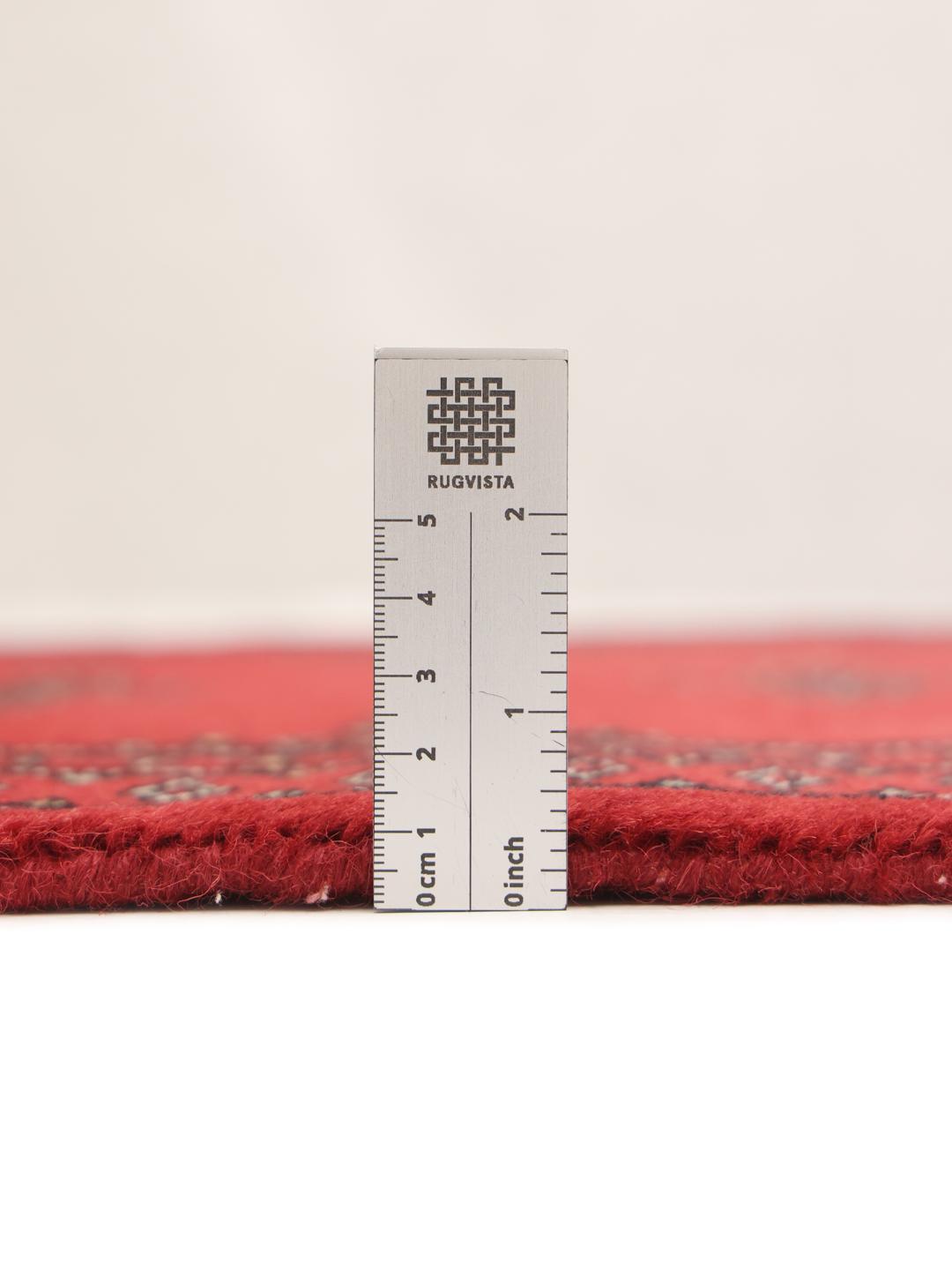 Red Pakistani wool runner rug with traditional motifs