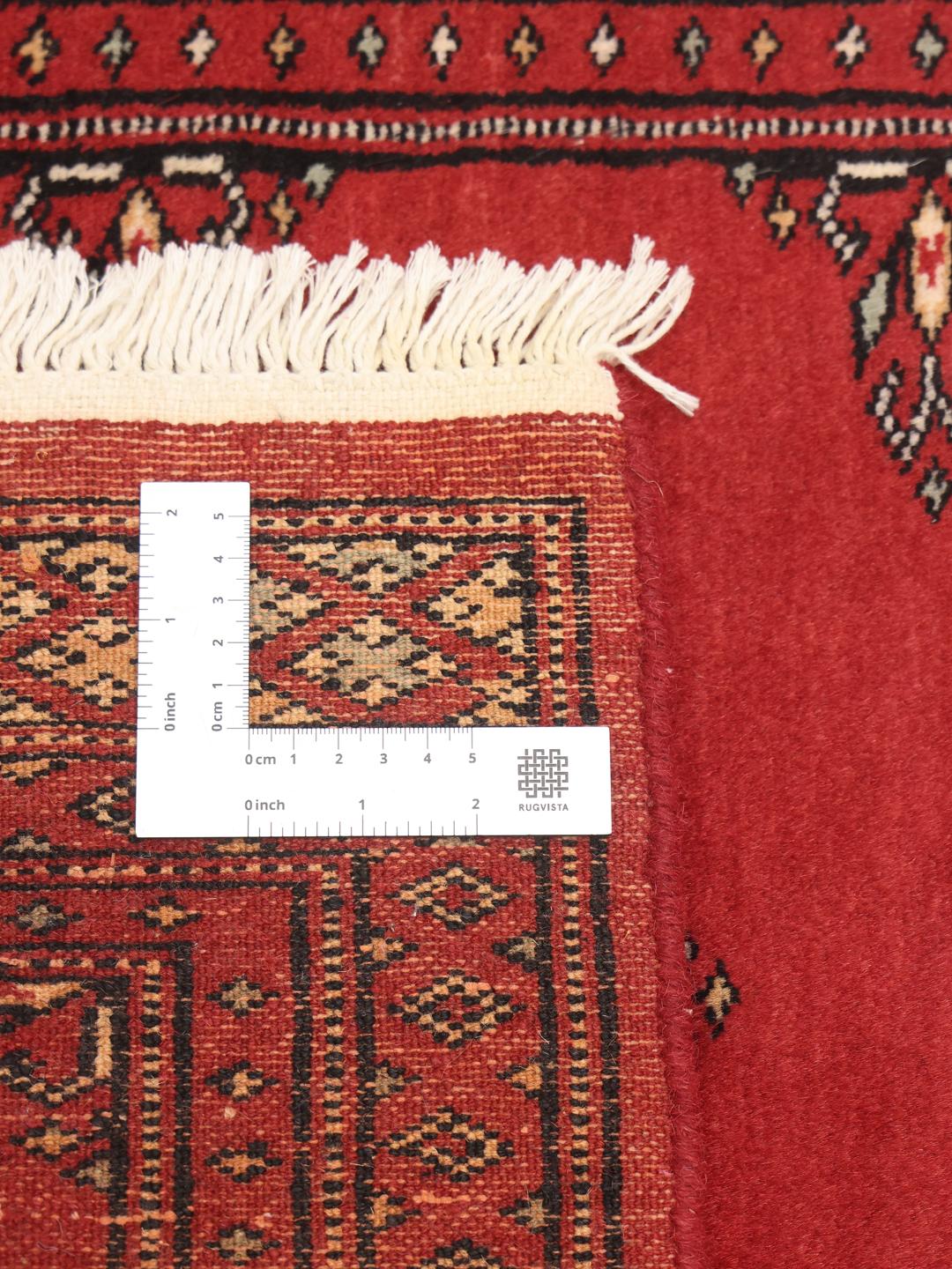 Red Pakistani wool runner rug with traditional motifs