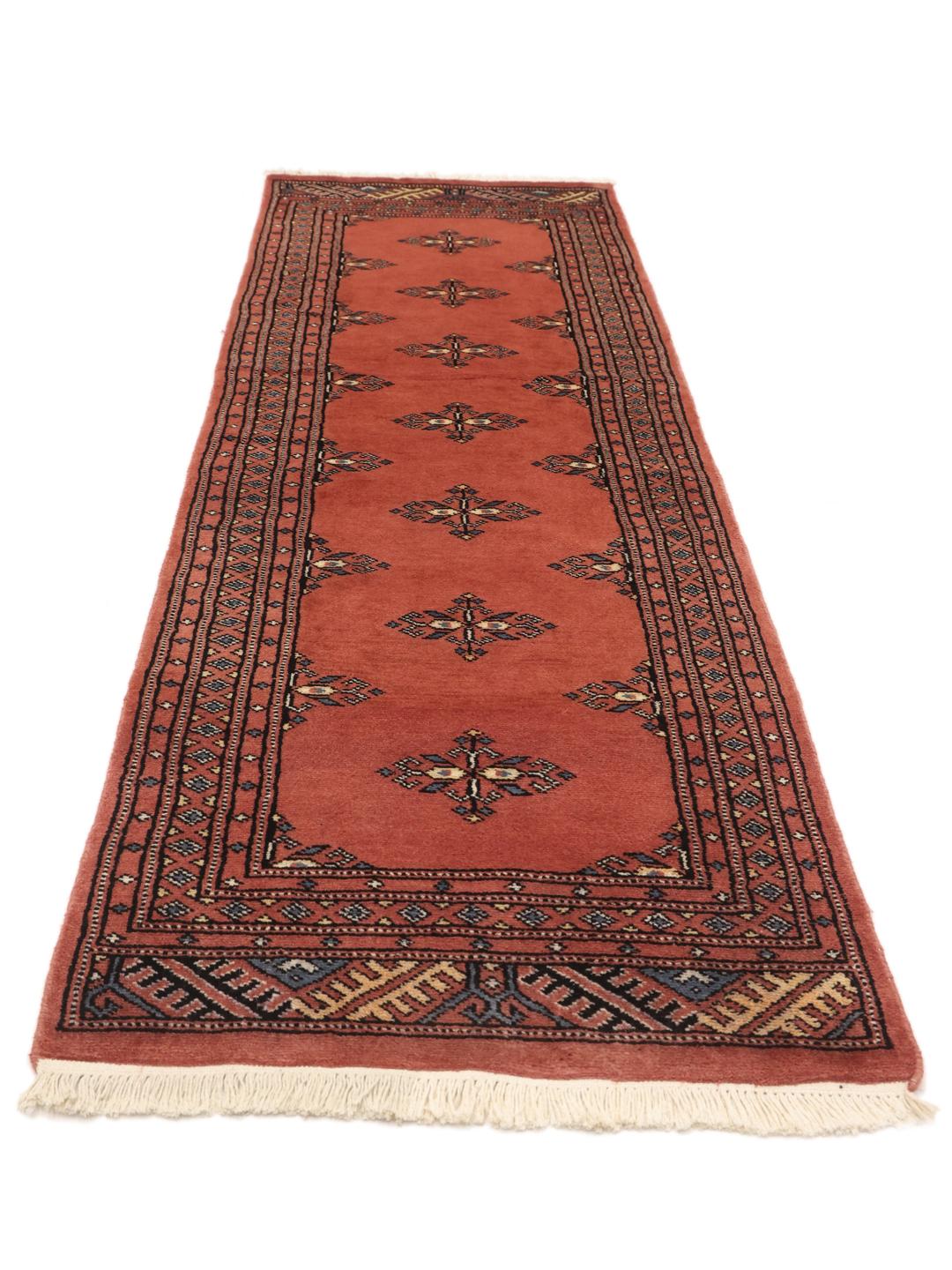 Handmade runner rug from Pakistan in red with traditional motifs