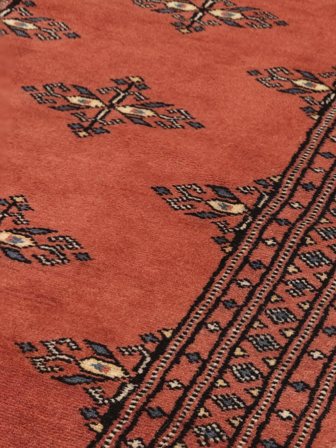 Handmade runner rug from Pakistan in red with traditional motifs