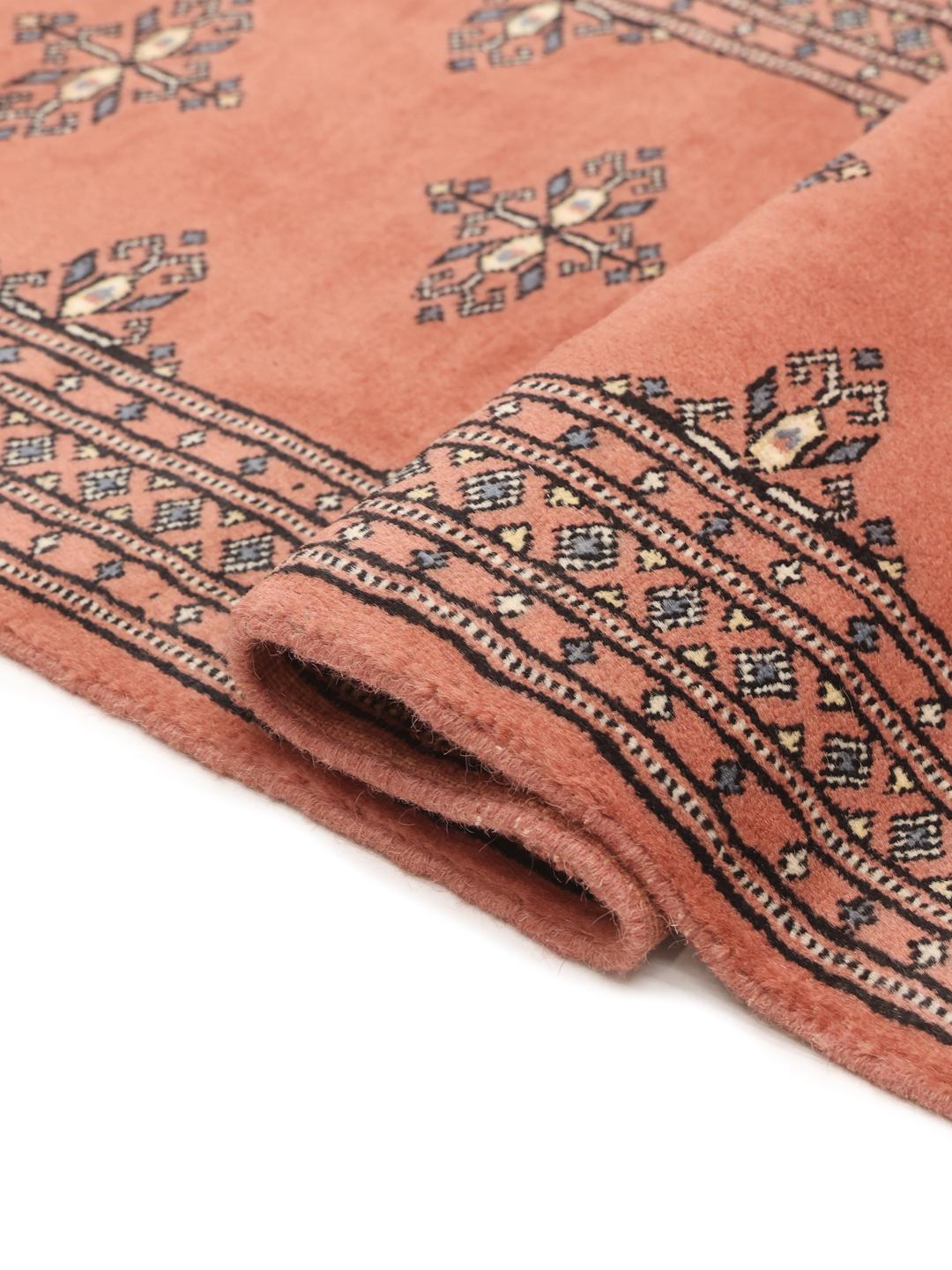 Handmade runner rug from Pakistan in red with traditional motifs