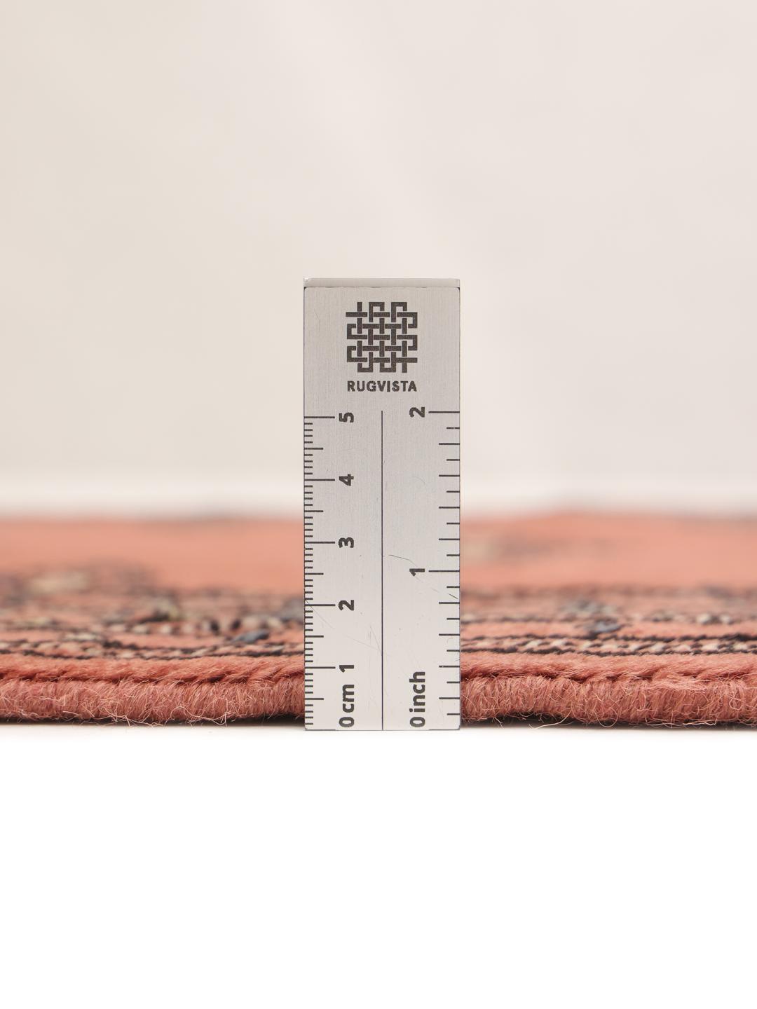 Handmade runner rug from Pakistan in red with traditional motifs