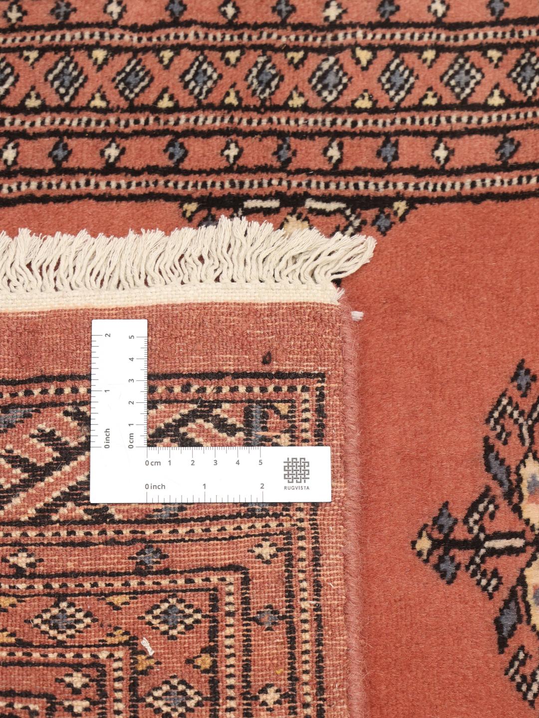 Handmade runner rug from Pakistan in red with traditional motifs