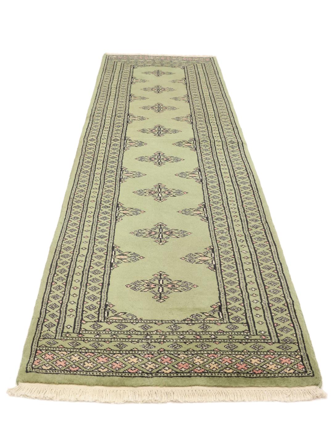 Handmade runner rug from Pakistan in light-green.