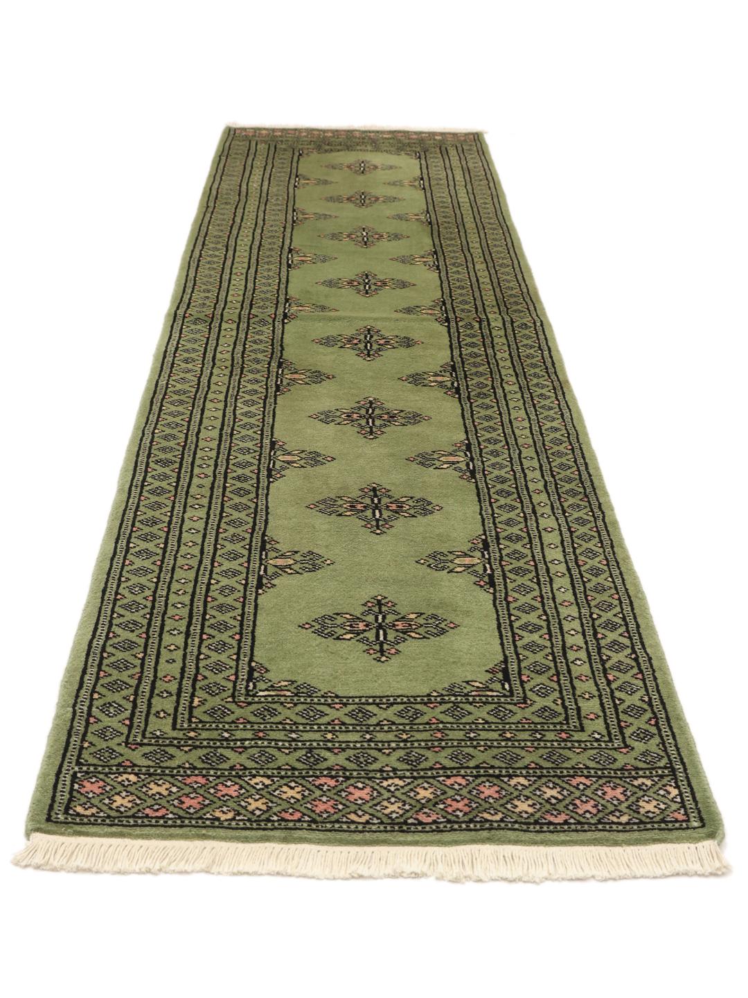 Handmade runner rug from Pakistan in light-green.