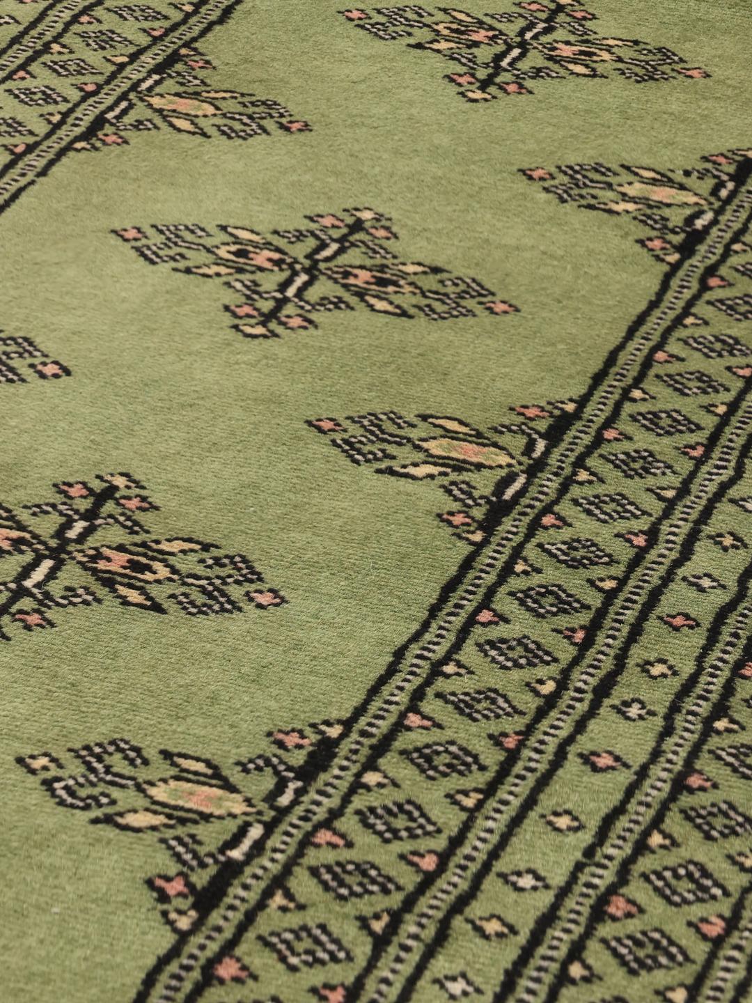 Handmade runner rug from Pakistan in light-green.