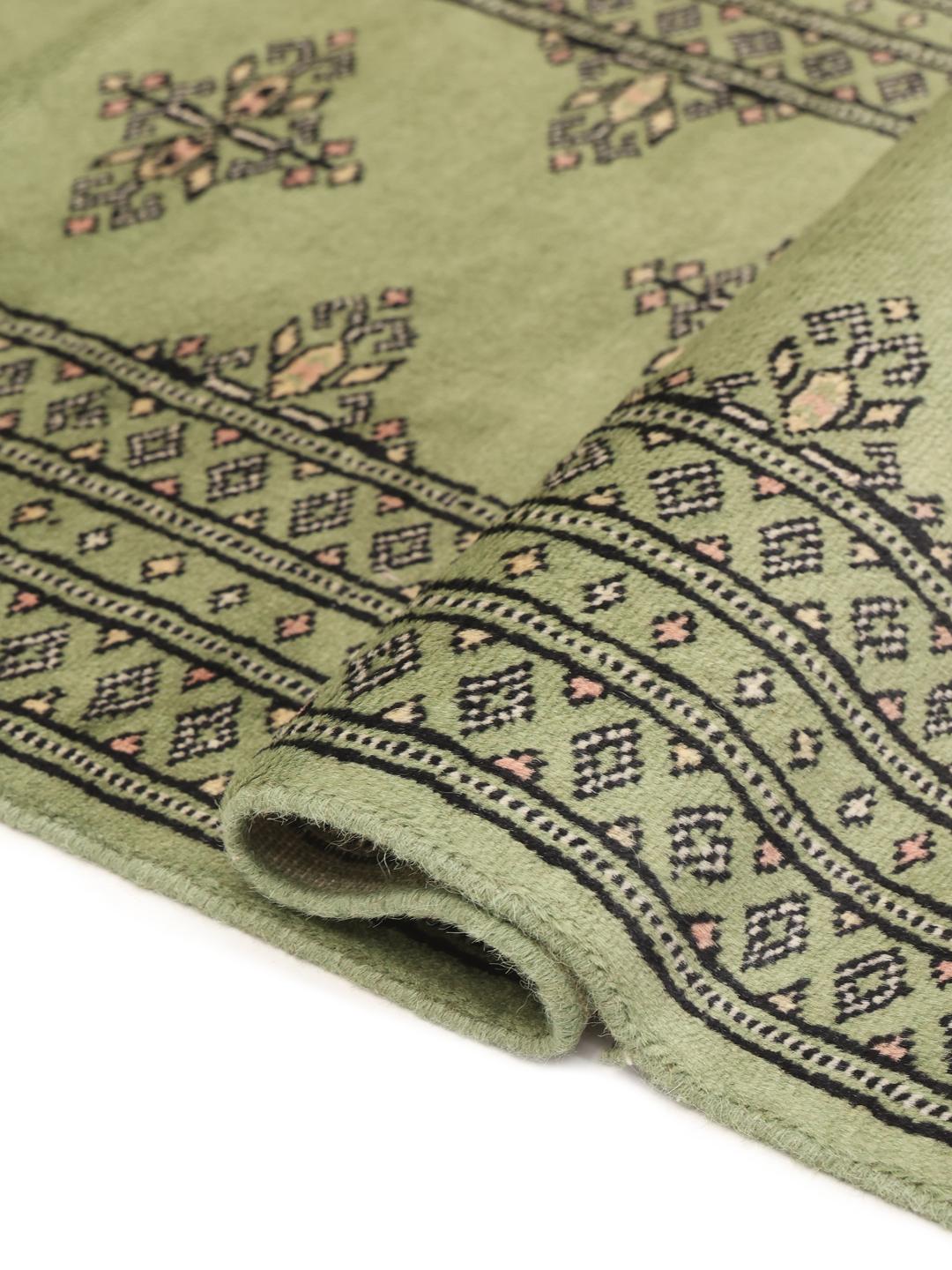 Handmade runner rug from Pakistan in light-green.
