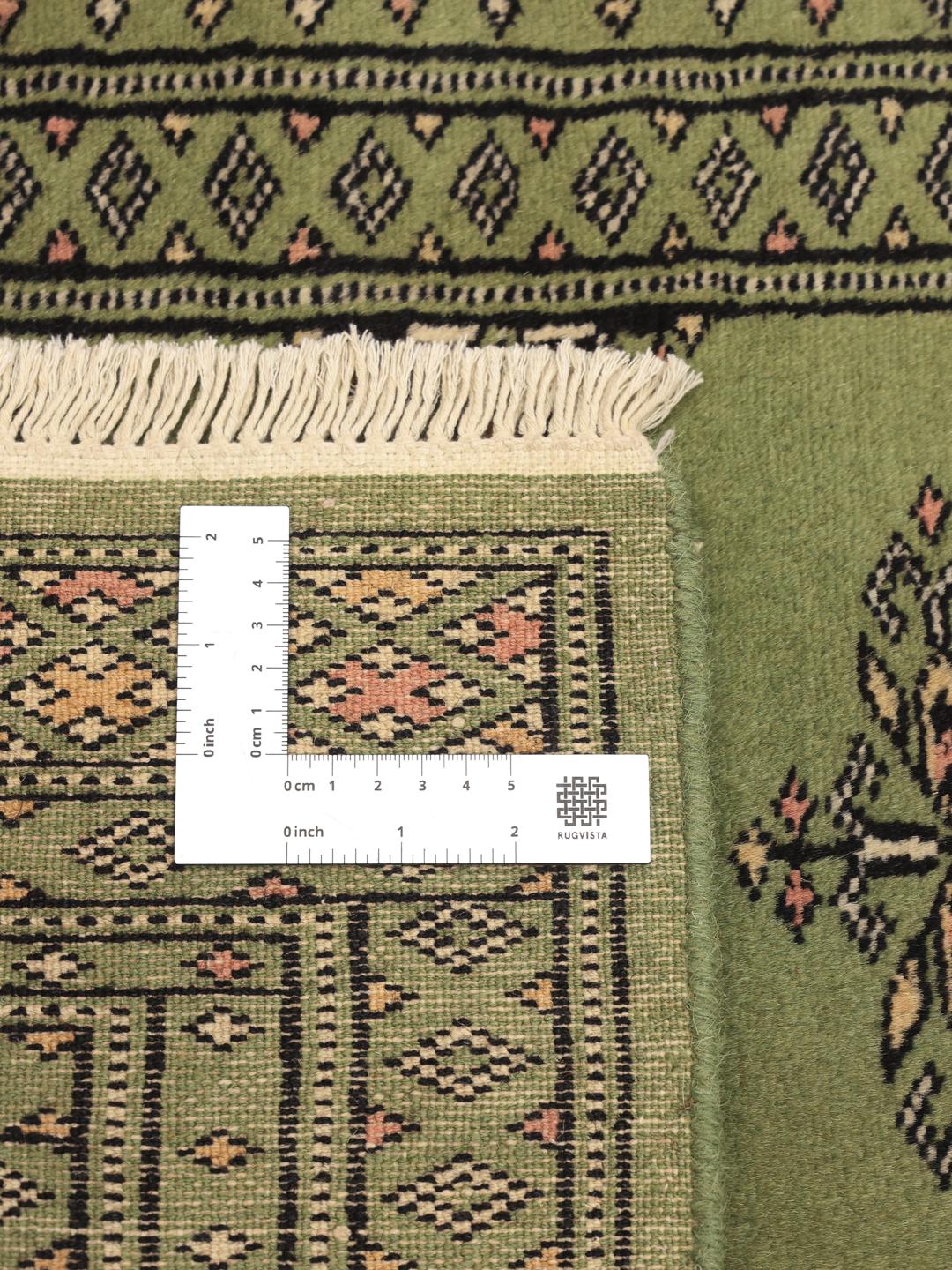 Handmade runner rug from Pakistan in light-green.