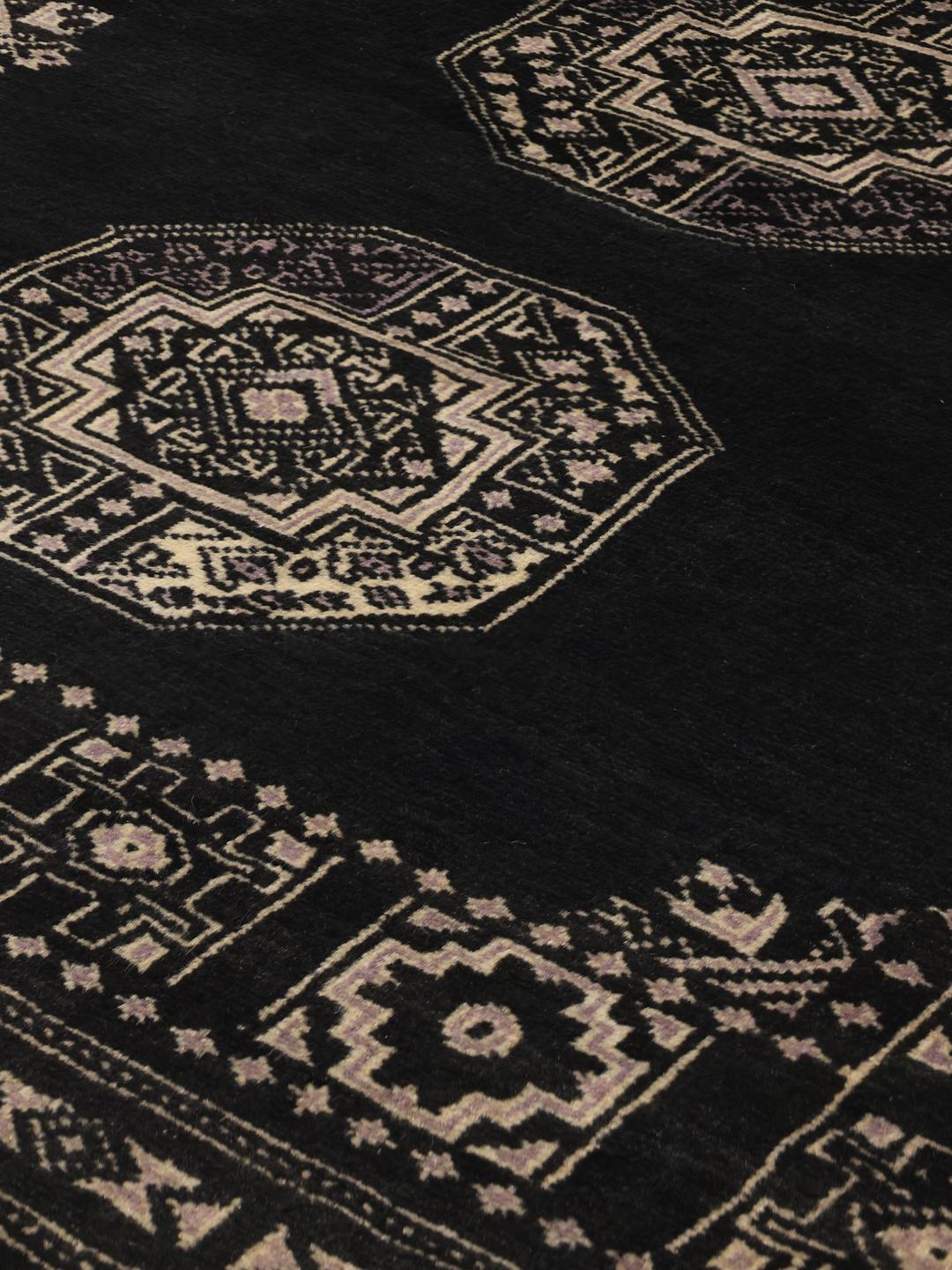 Hand-knotted Pakistani rug in black with traditional motifs
