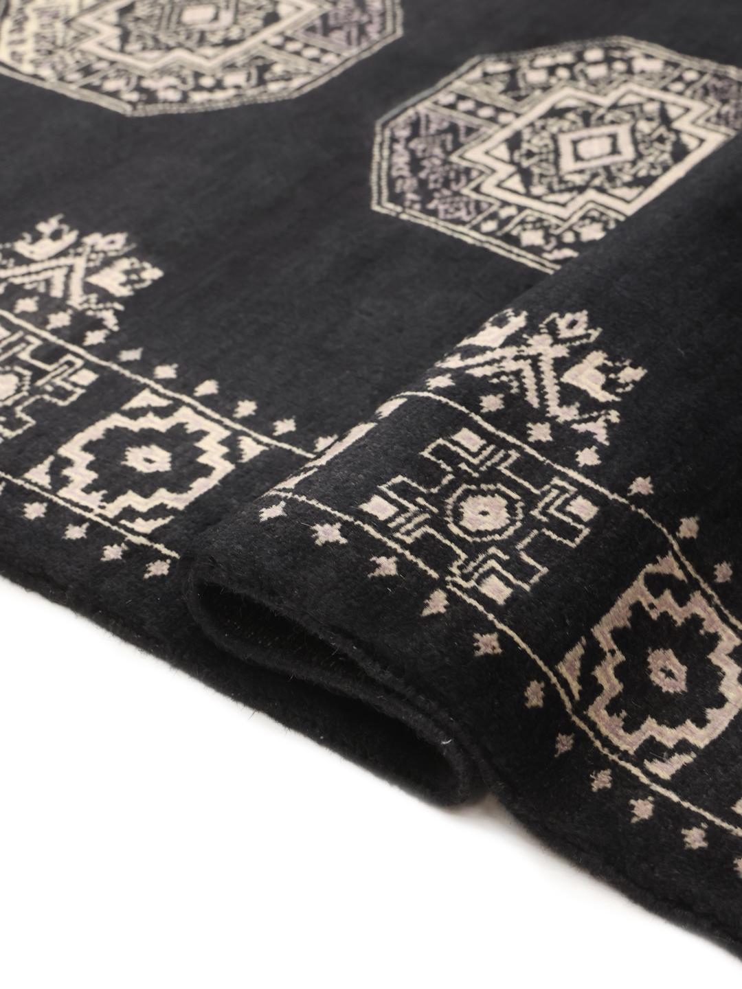 Hand-knotted Pakistani rug in black with traditional motifs