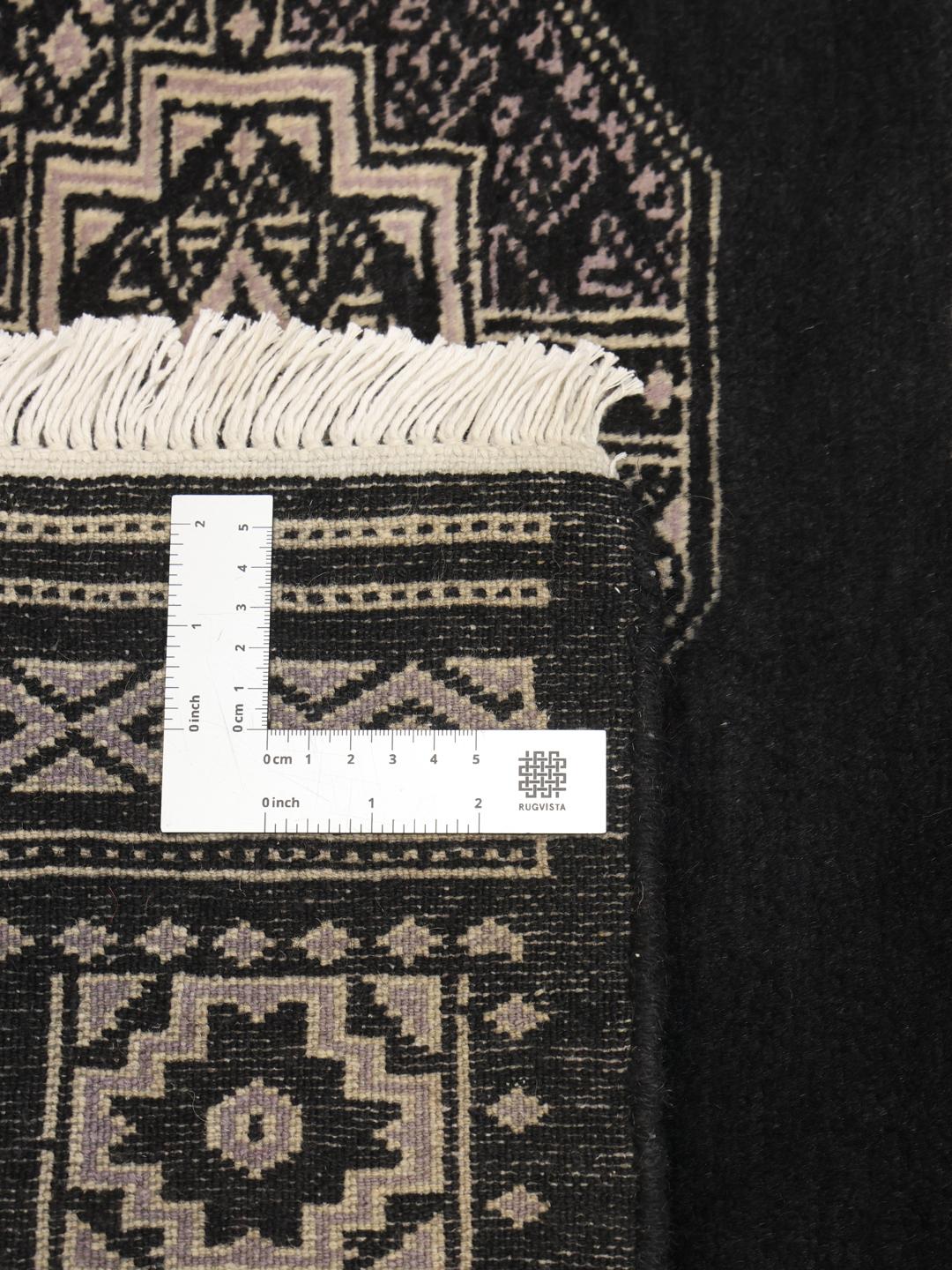Hand-knotted Pakistani rug in black with traditional motifs