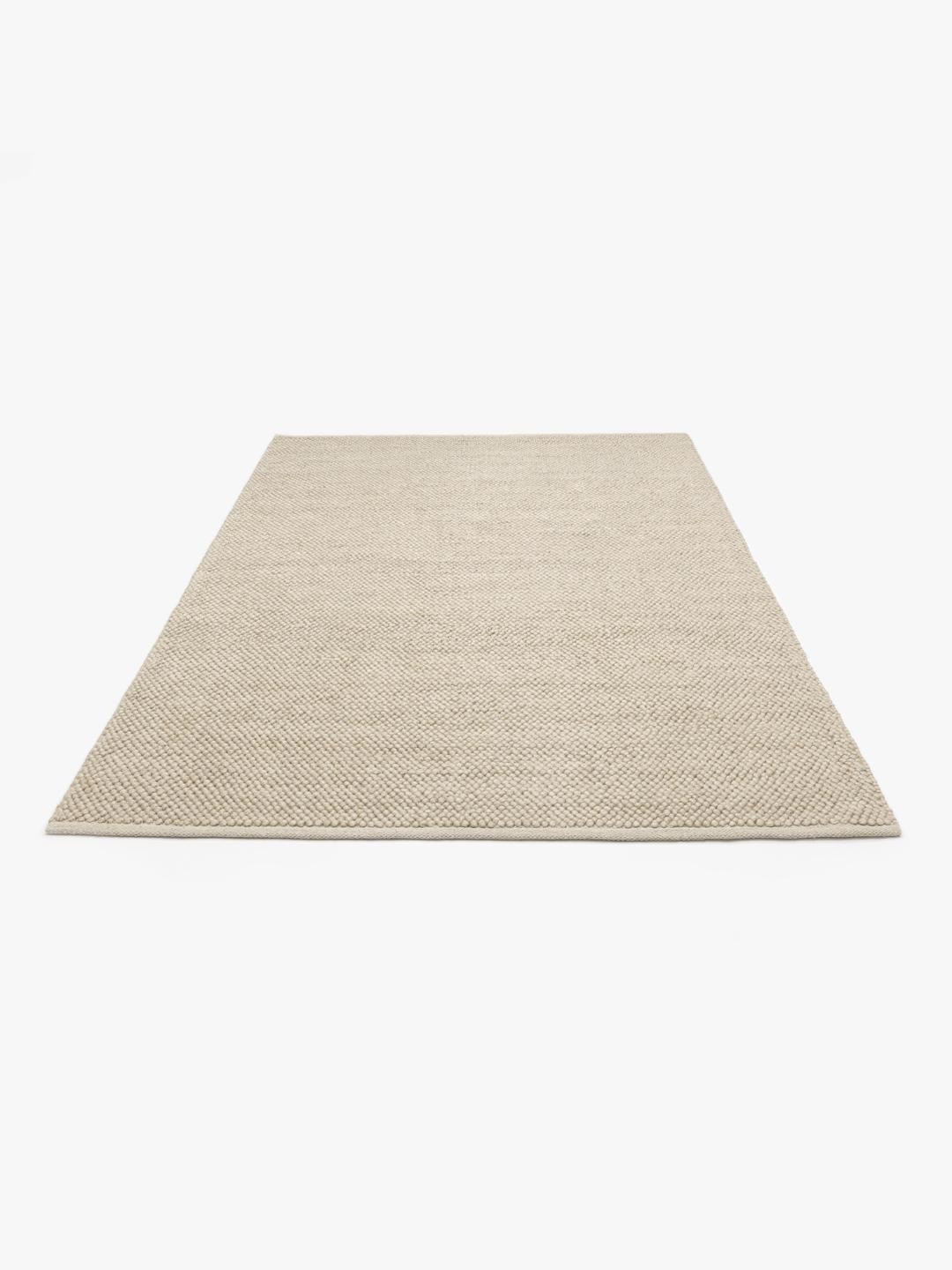Beige wollen vloerkleed met gestructureerd oppervlak