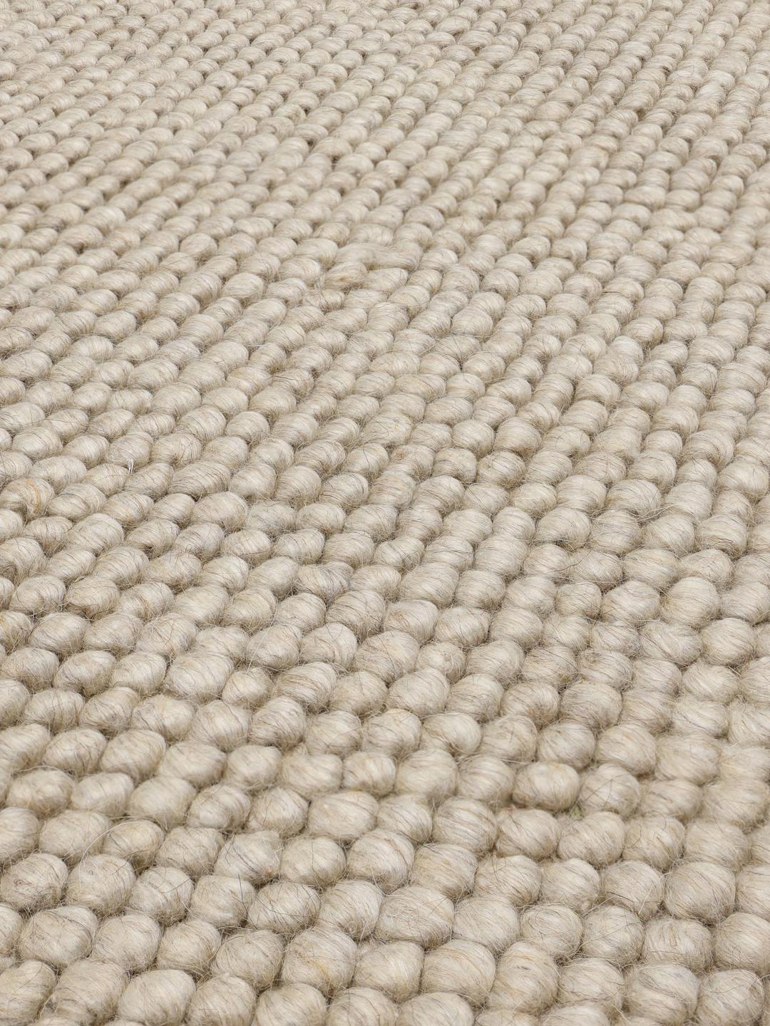Beige wollen vloerkleed met gestructureerd oppervlak