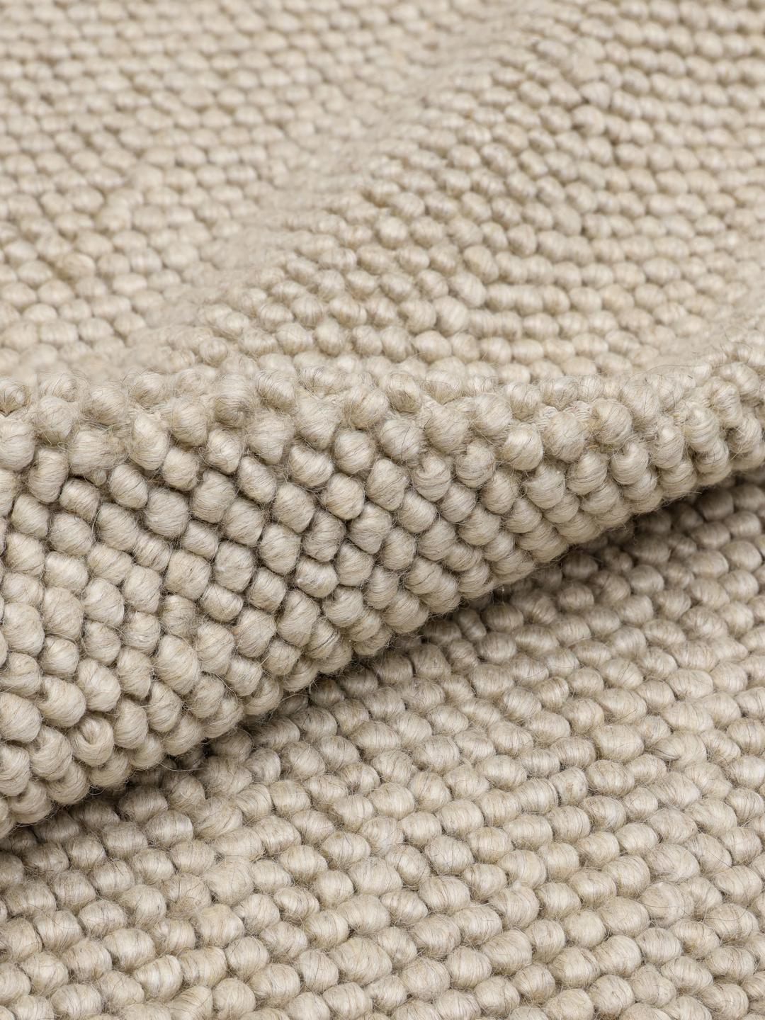 Beige wollen vloerkleed met gestructureerd oppervlak