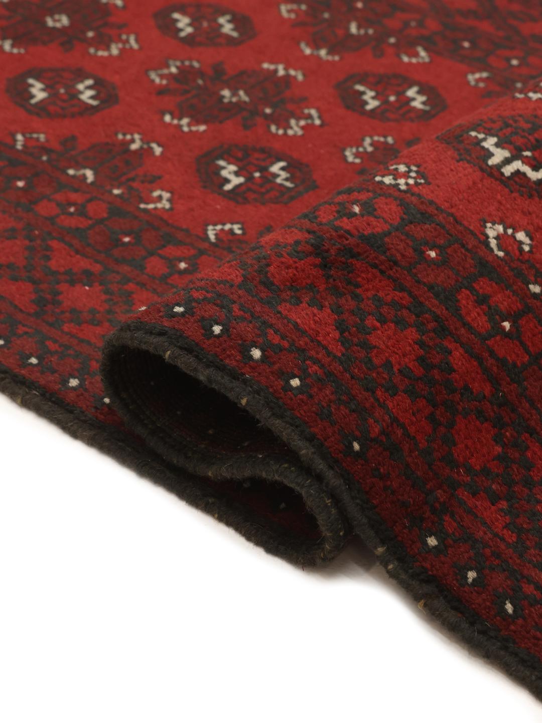 Hand-knotted runner rug from Afghanistan in dark red and black geometric patterns