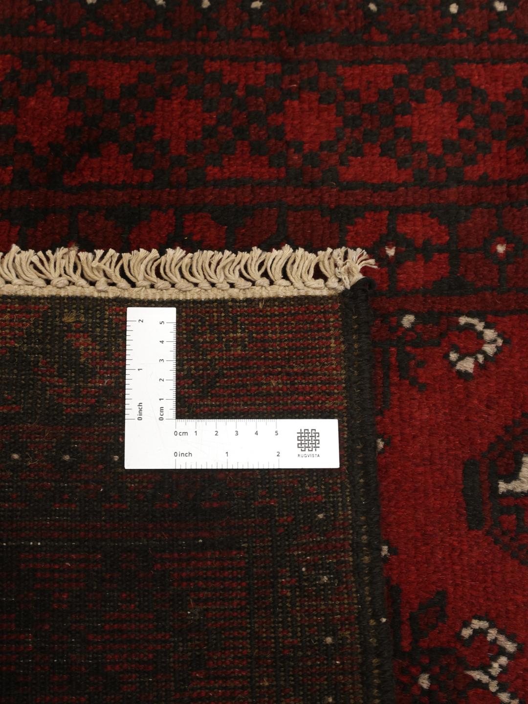 Hand-knotted runner rug from Afghanistan in dark red and black geometric patterns