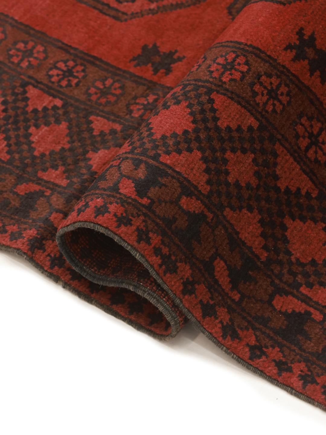 Hand-knotted dark-red rug from Afghanistan with traditional geometric medallions