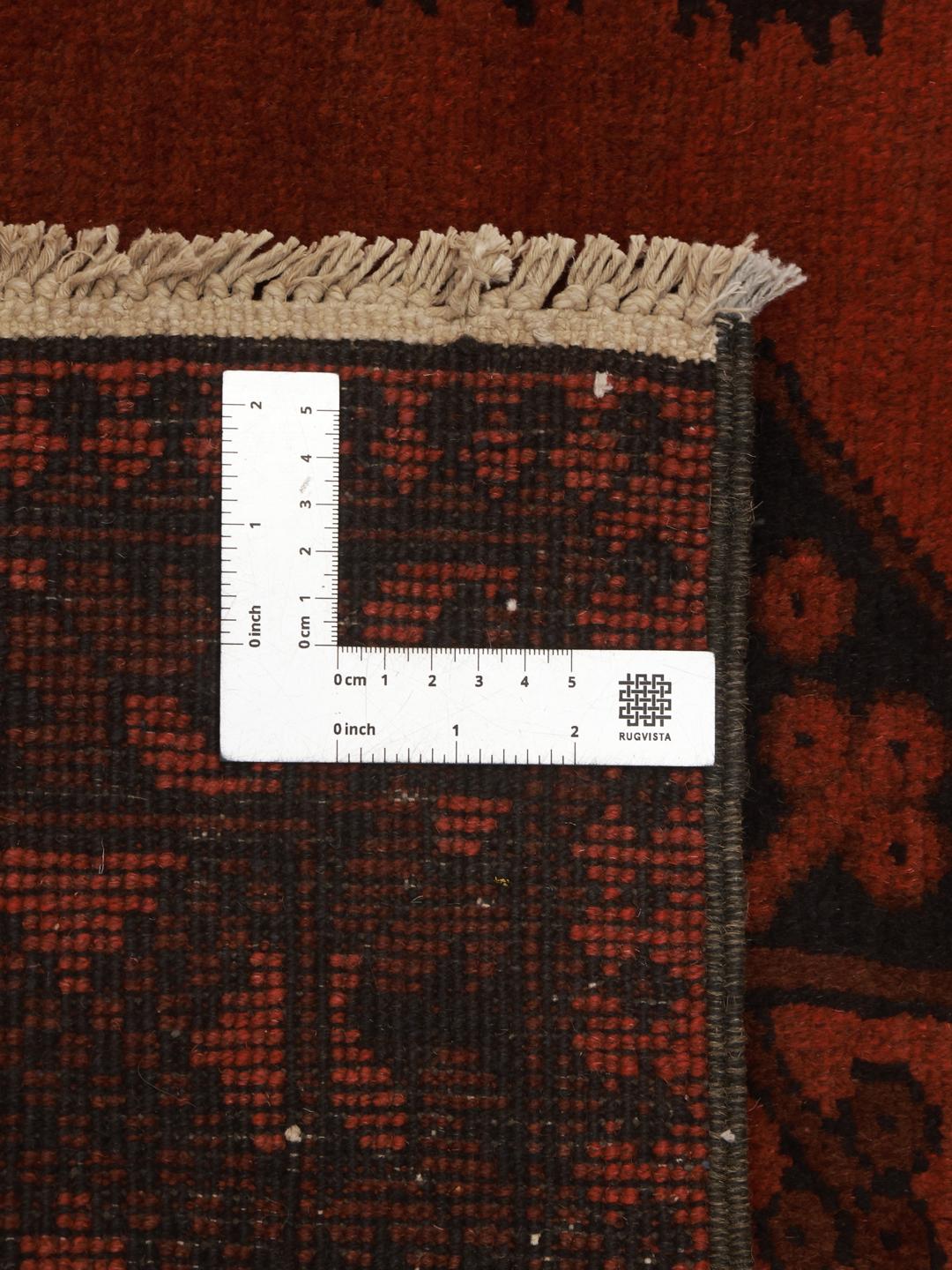 Hand-knotted dark-red rug from Afghanistan with traditional geometric medallions