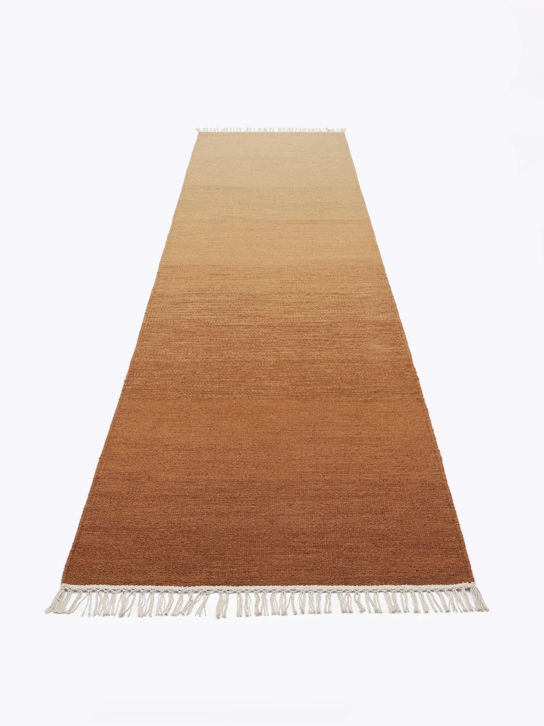 Handgeweven roestrood loper vloerkleed met een warm gradient ontwerp en franjes