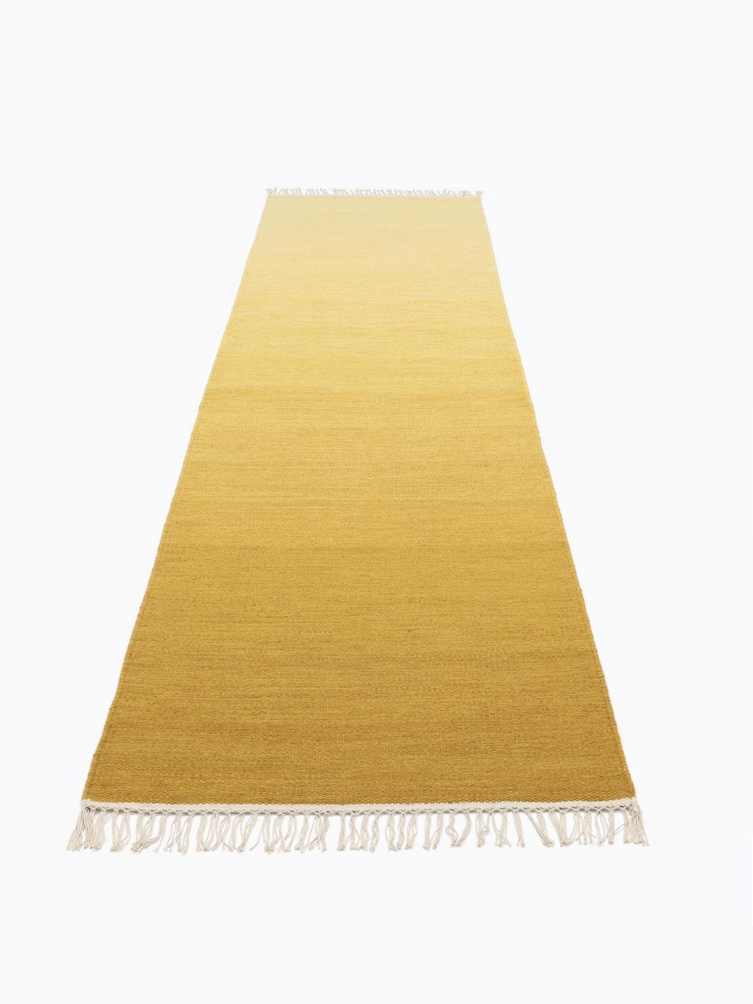 Handgeweven geel loper vloerkleed met een vloeiend kleurverloop en witte franjes