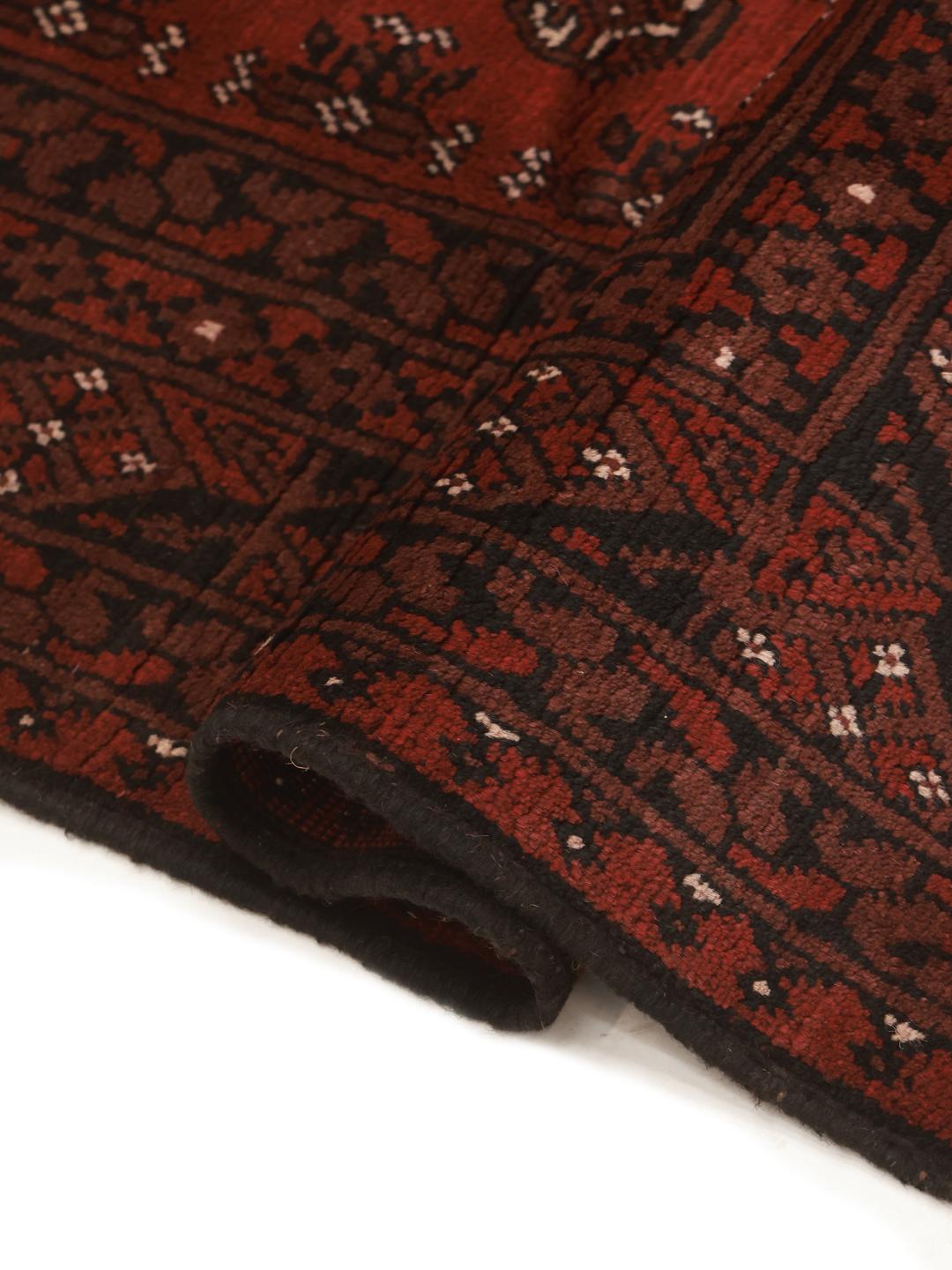 Rug originating from Afghanistan in dark-red