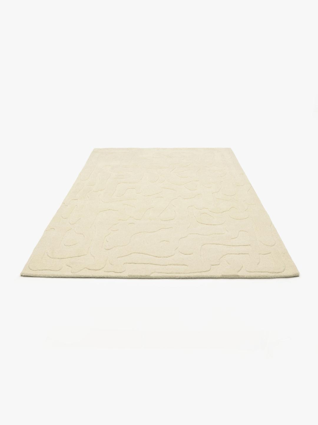 Met de hand getuft wit wollen vloerkleed met een gesneden reliëfpatroon