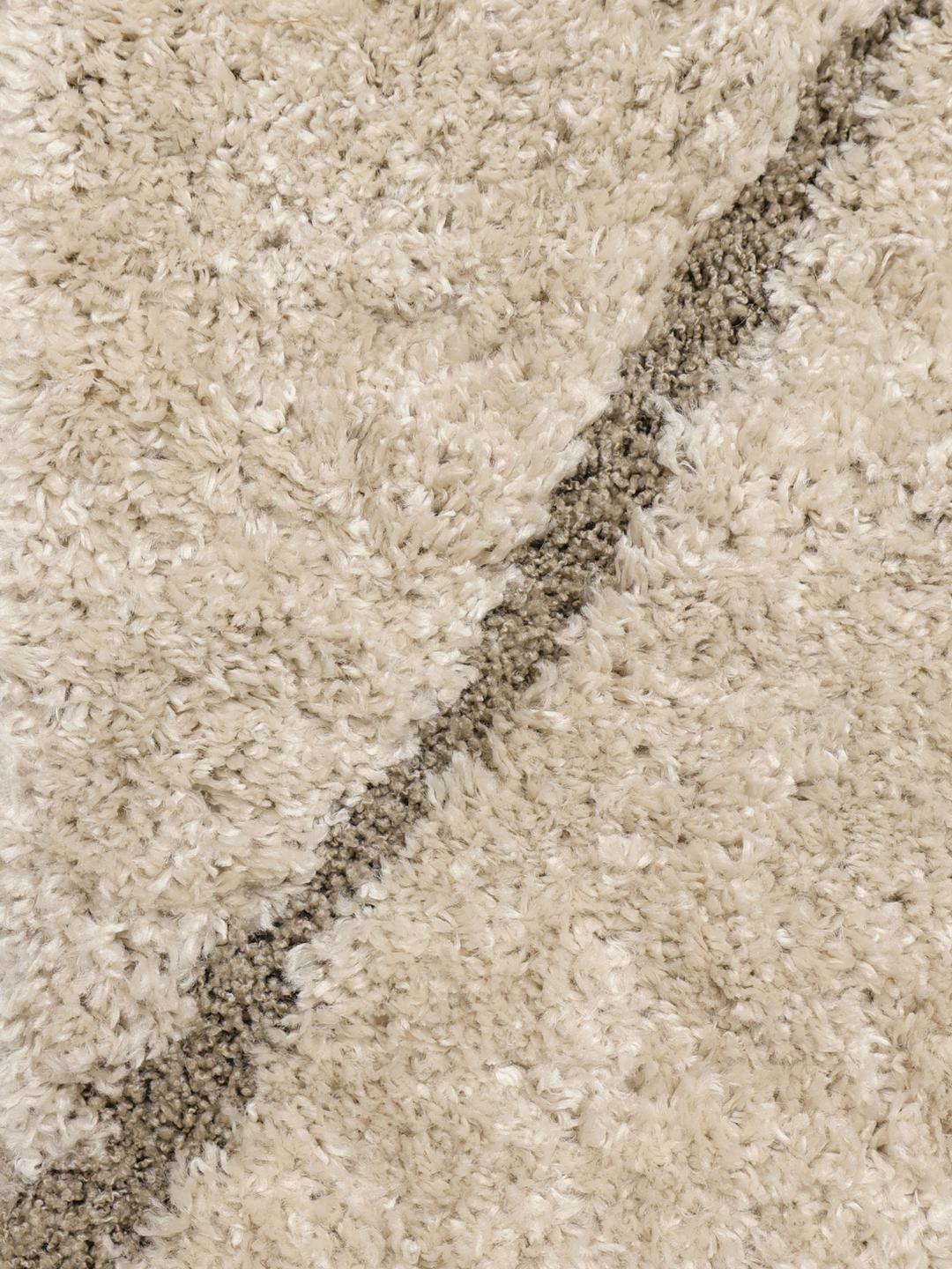 Hoogpolig beige vloerkleed met organische golvende lijnen