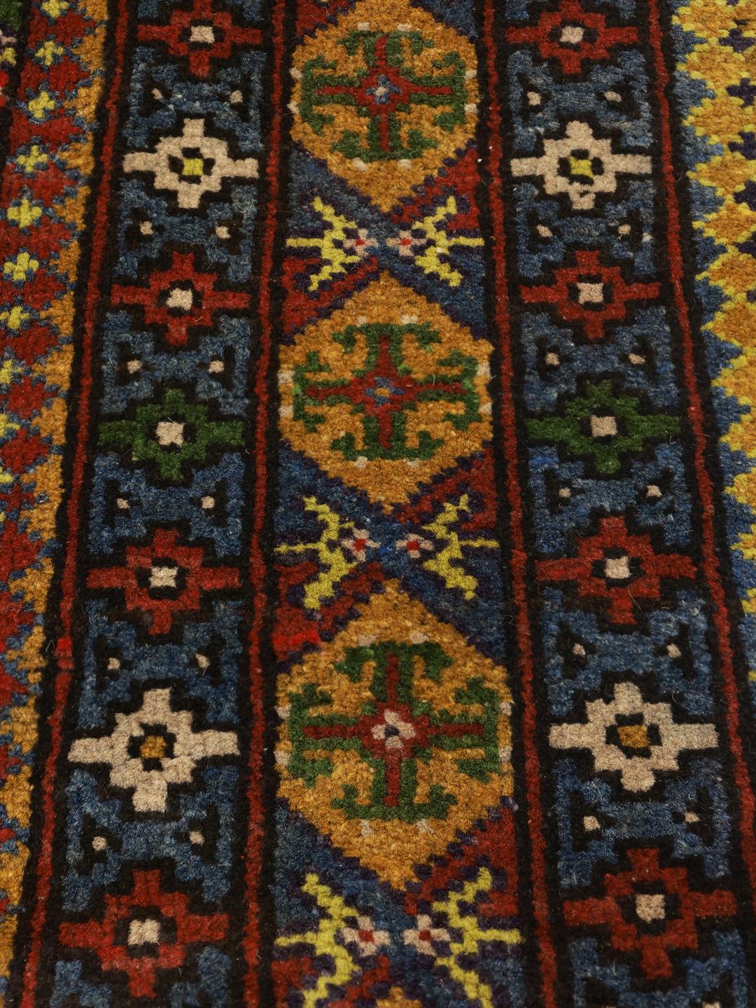 Handgeknoopt groen vloerkleed uit Afghanistan met geometrische patronen