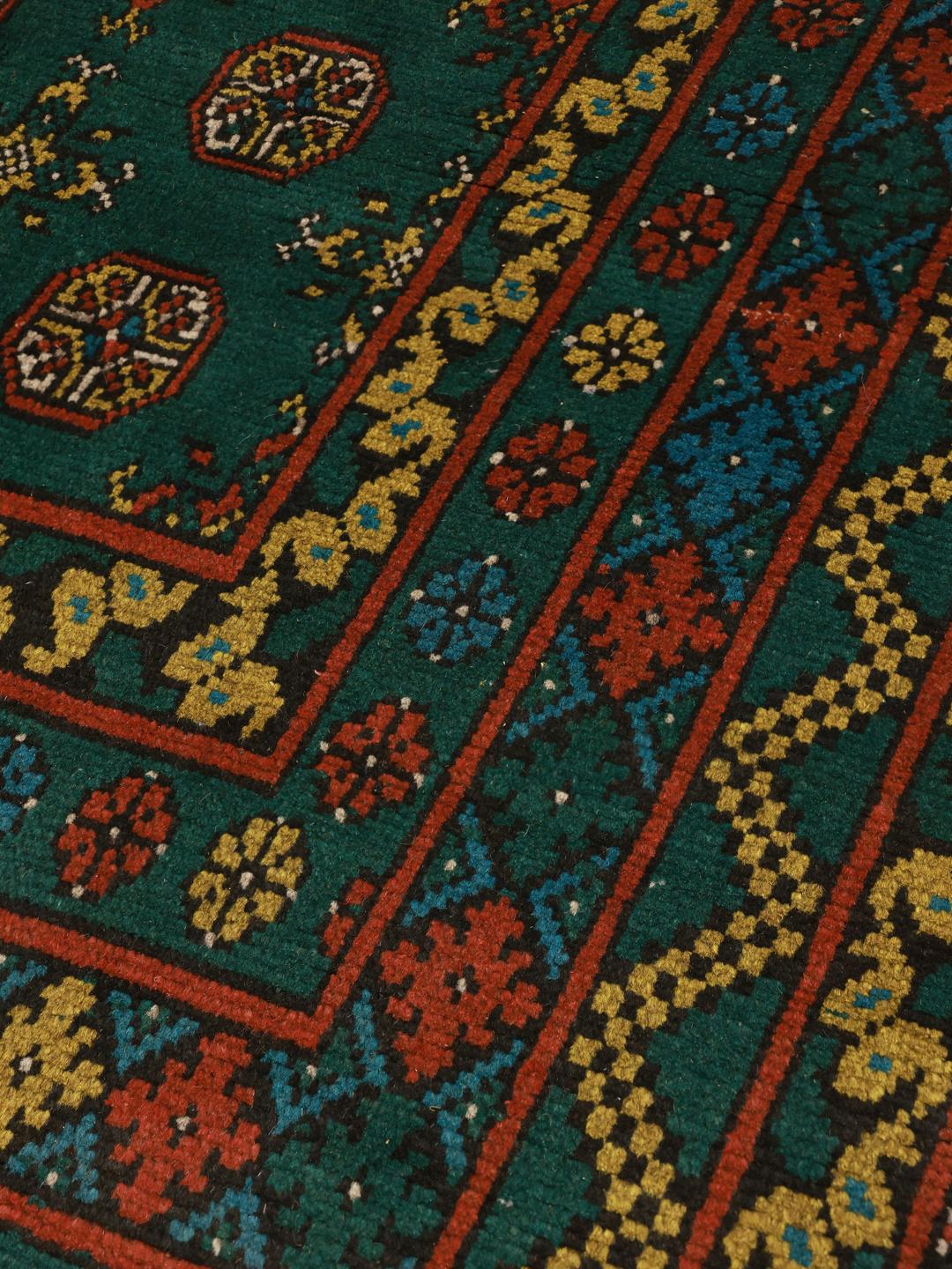 Handgeknoopt donkergroen wollen vloerkleed uit Afghanistan