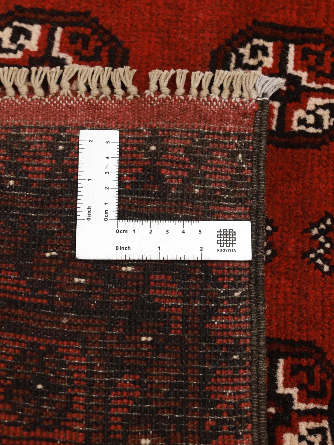 Håndknyttet afghansk uldtæppe i rød og mørkerød med stammemønstre