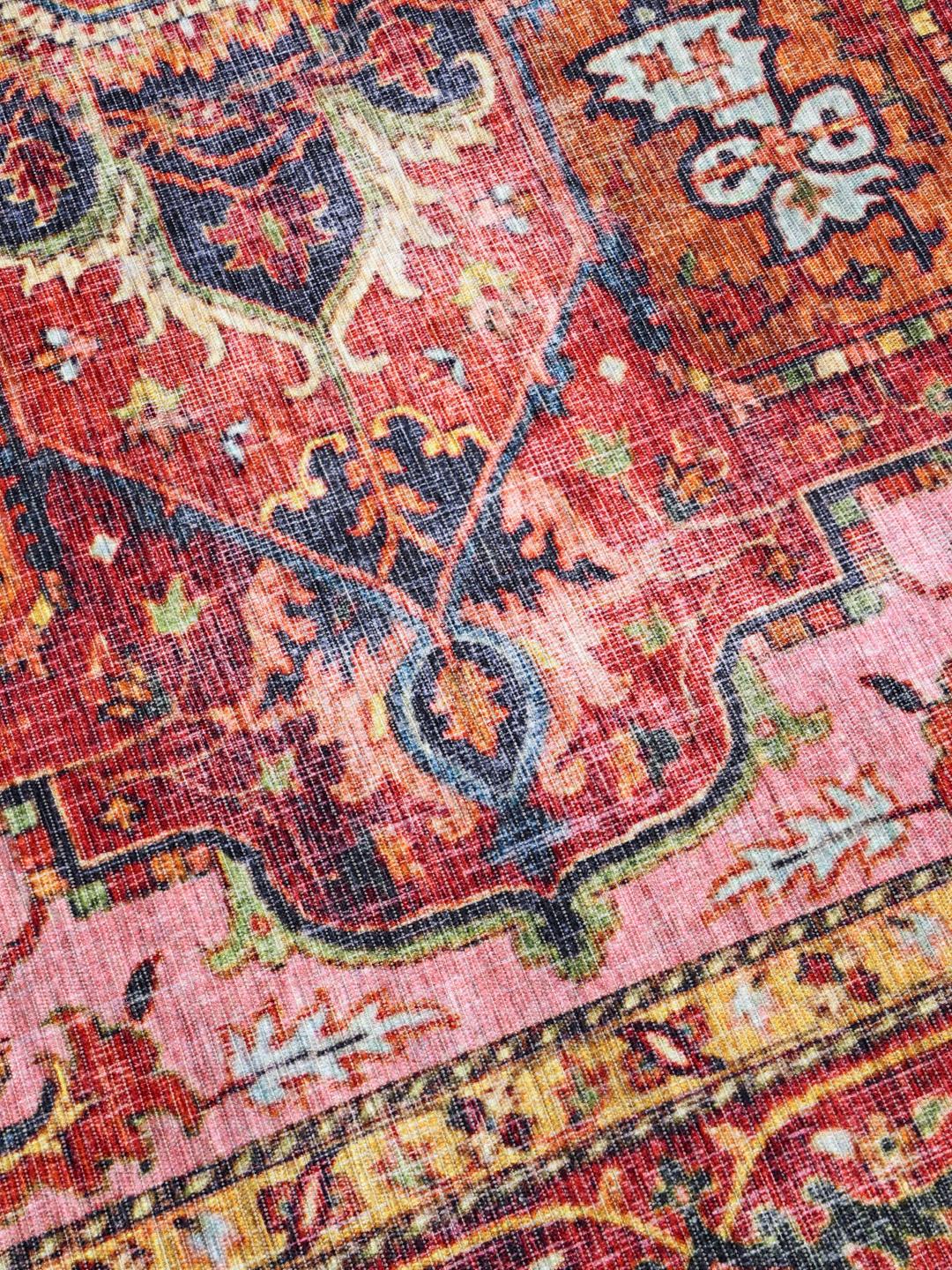 Red and pink runner rug with a central medallion design