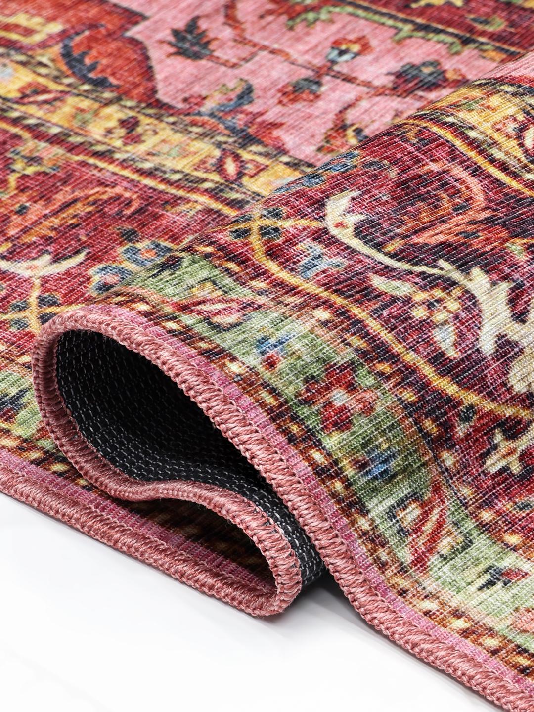 Red and pink runner rug with a central medallion design