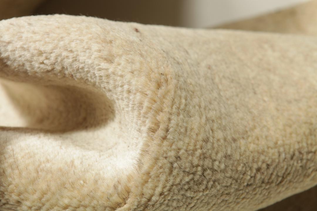 En håndknyttet beige løber med et minimalistisk design fra Mellemøsten.