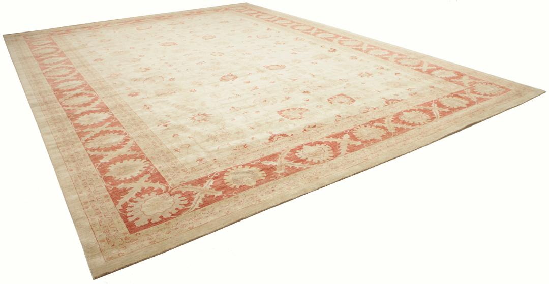 A large hand-knotted rug from Pakistan featuring a beige field and terracotta floral border.