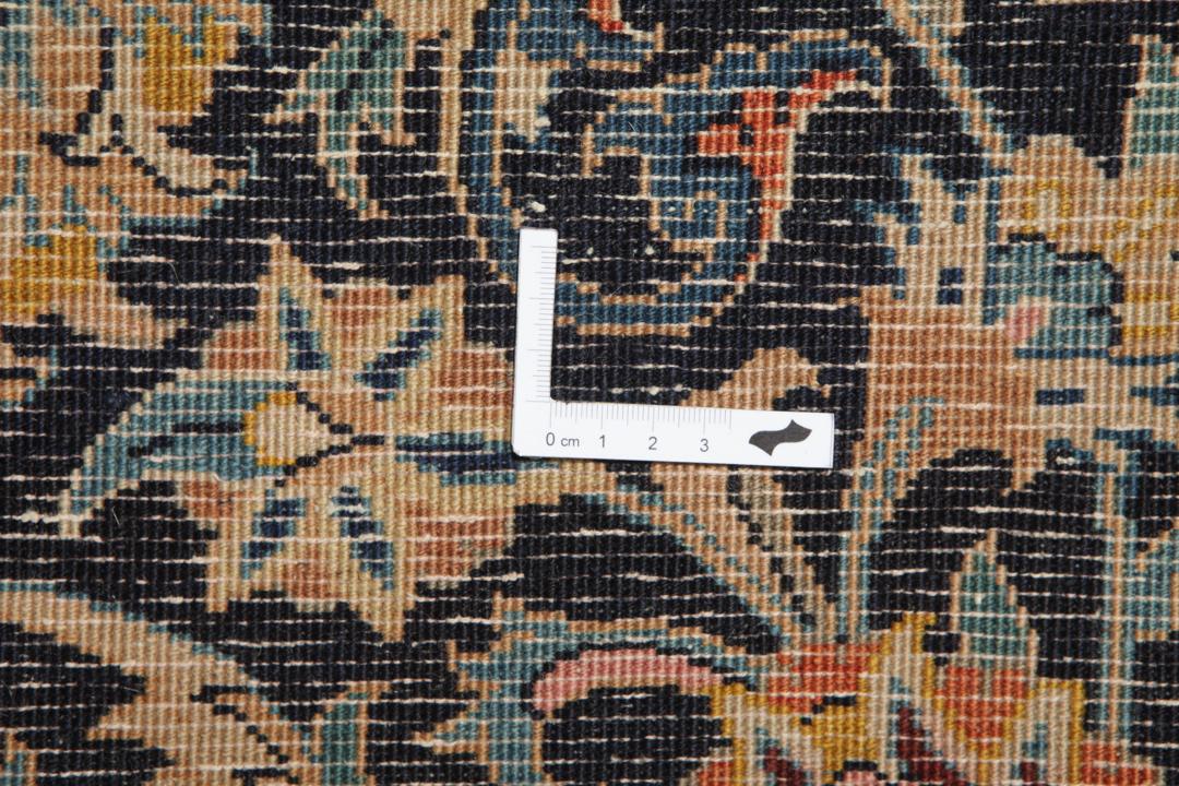 A large rectangular hand-knotted Mashad Astan Ghods rug with a beige field and floral motifs