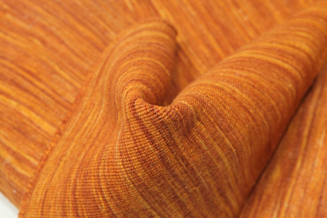 Handgeweven loper van wol in oranje