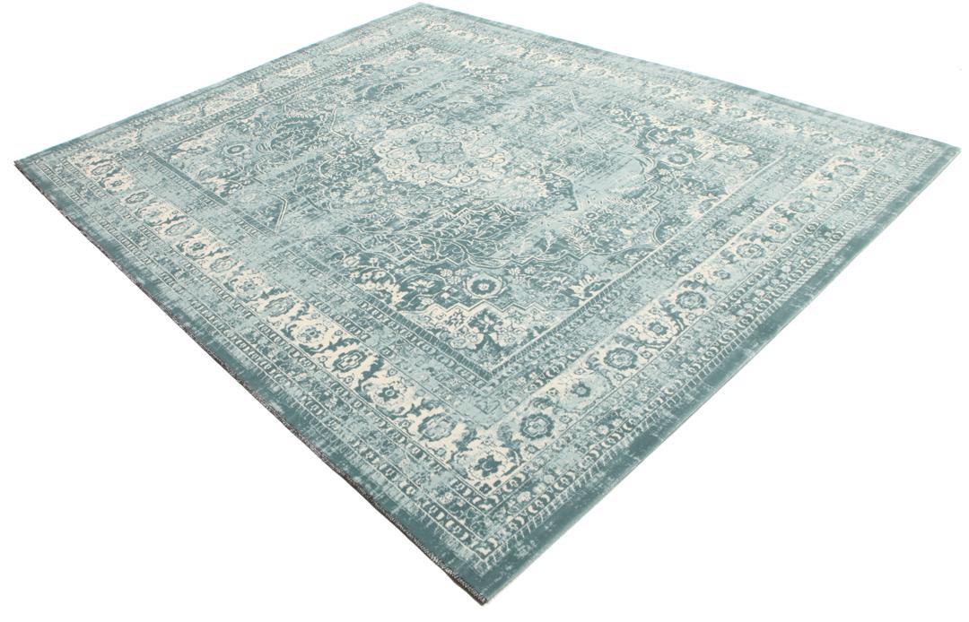 Light blue rug with a traditional patterned border and central medallion.
