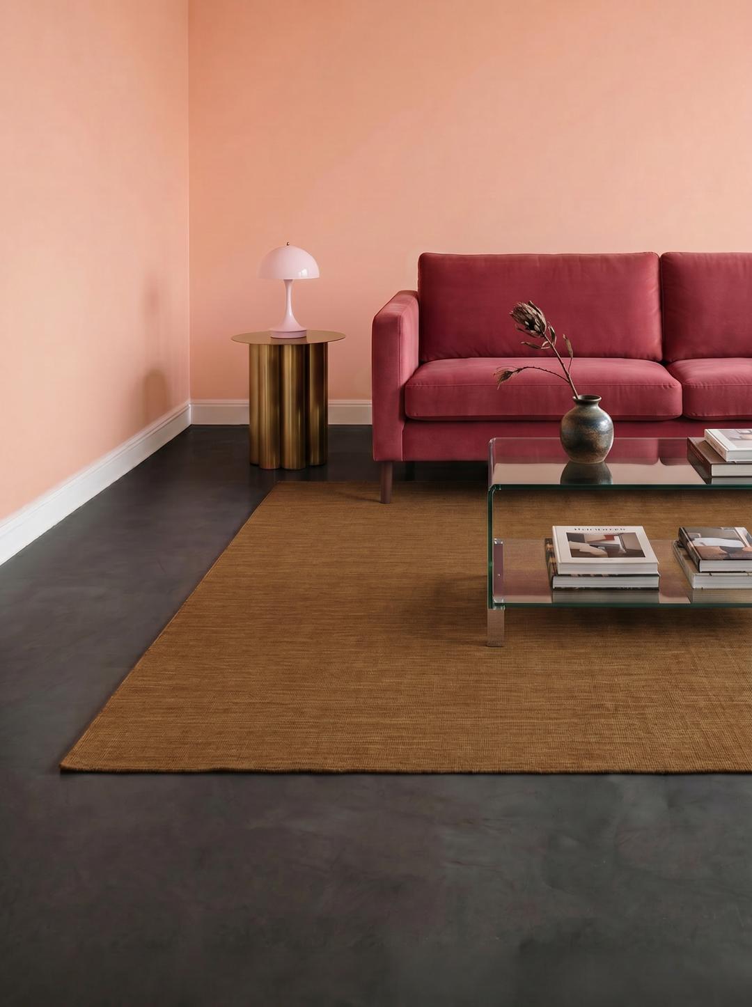 Square brown rug with a flat woven wool texture