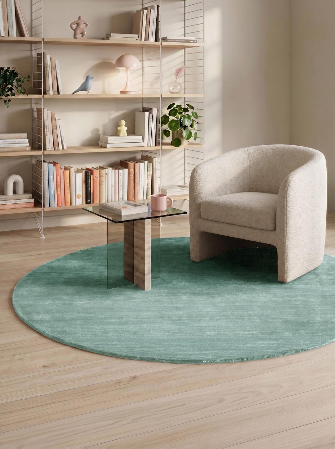 Round teal rug made from wool