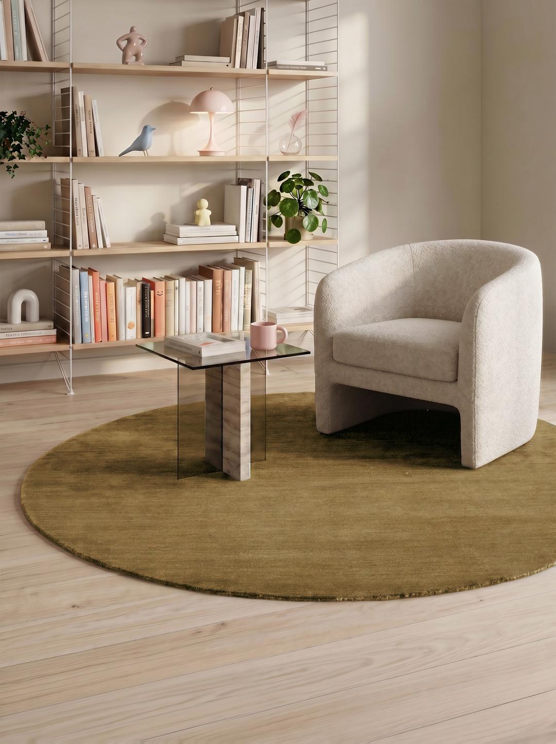 A round beige handloom rug with a soft wool pile