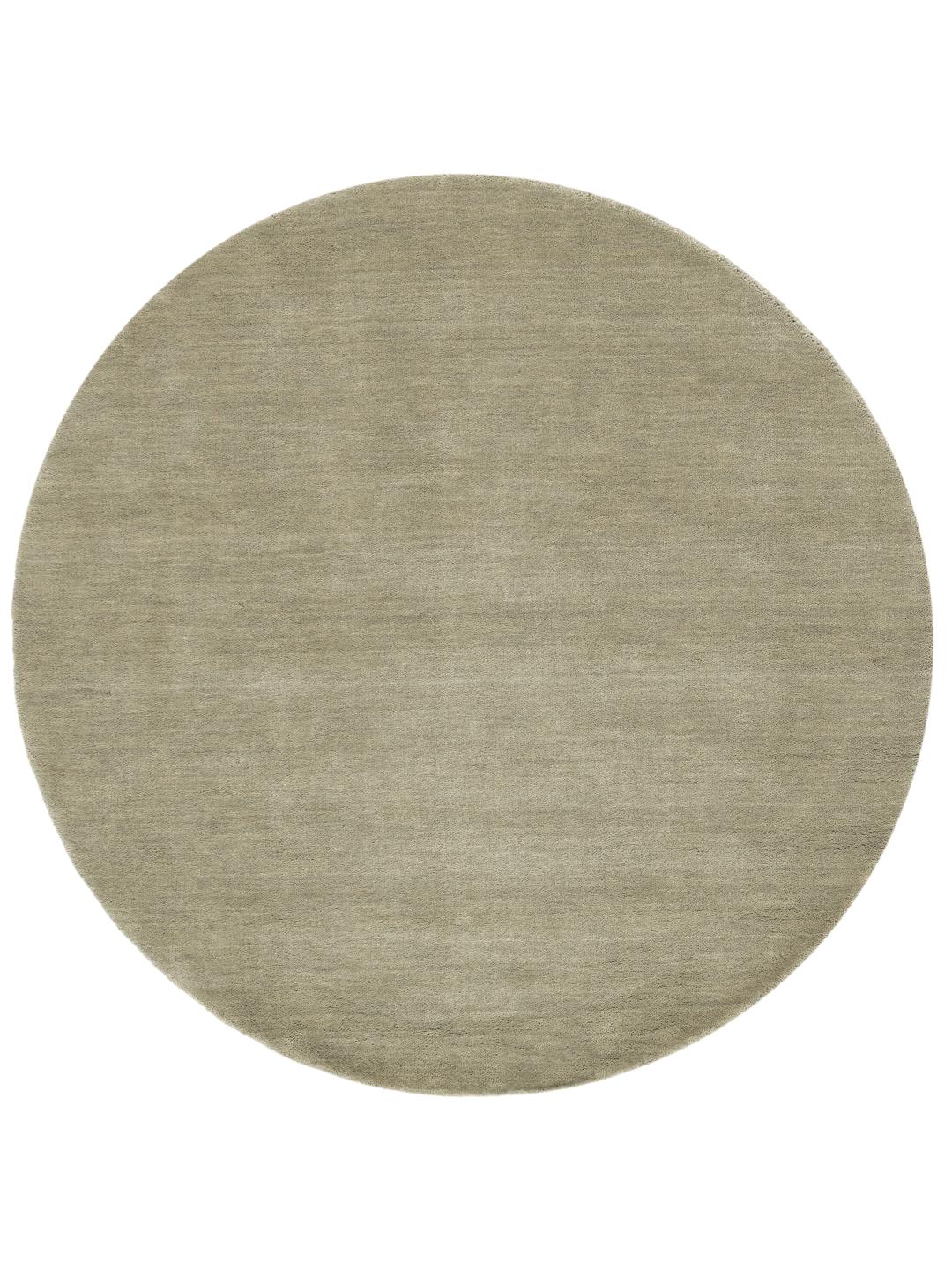 Round light green rug with a soft pile texture