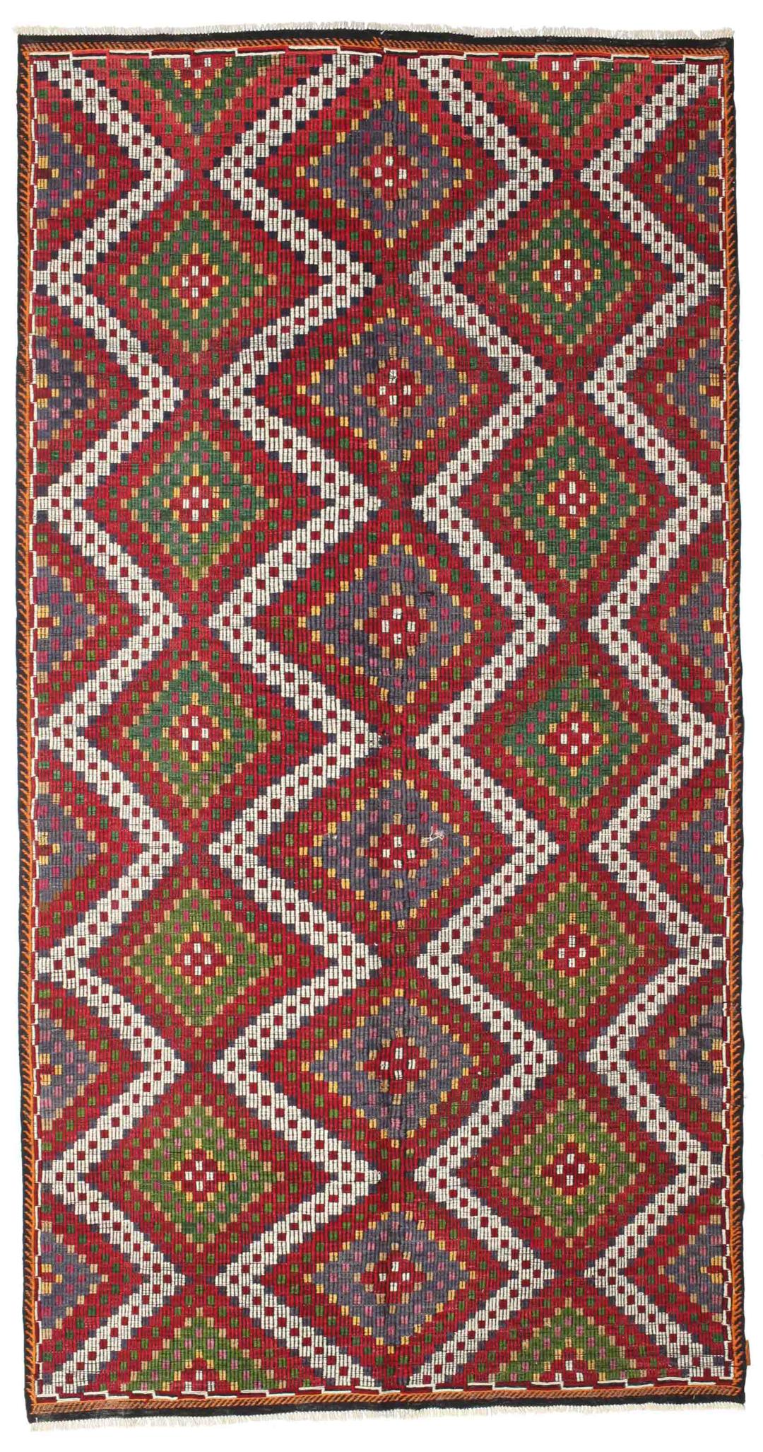 Handgeweven Turks kelimtapijt met levendige geometrische patronen in rood, groen en wit